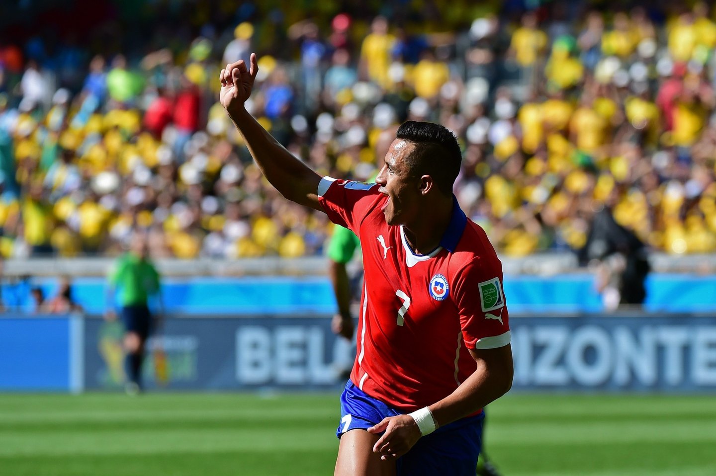 Chile's forward Alexis Sanchez celebrates after scoring a goal during the Round of 16 football match between Brazil and Chile at The Mineirao Stadium in Belo Horizonte during the 2014 FIFA World Cup on June 28, 2014. AFP PHOTO / MARTIN BERNETTI