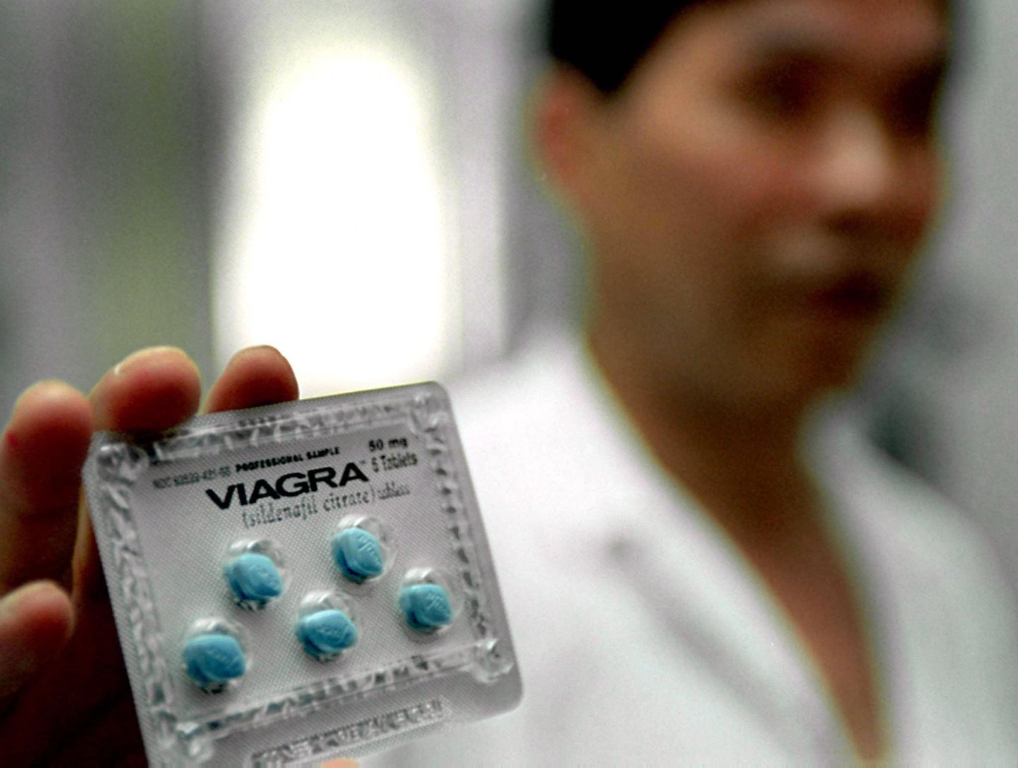 SHANGHAI, CHINA - JULY 5: A Chinese doctor shows the anti-impotence drug Viagra at a hospital in Shanghai 05 July 2000. Viagra officially made its debut in mainland China 03 July and is now available by prescription in full-service Chinese hospitals for the retail price of 71 yuan (8.60 USD) for a 25mg-dose and 99 yuan (11.90 USD) for a 50mg-dose per tablet. In the Chinese market, Viagra, sold under the Chinese name of Wan Ai Ke, is being produced in a joint venture factory between Pfizer pharmaceutical and Dalian pharmaceutical in the northeastern Chinese city of Dalian. AFP PHOTO/LIU Jin (Photo credit should read LIU JIN/AFP/Getty Images)