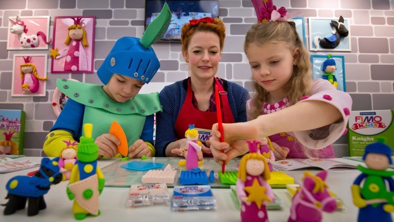 MUNICH, GERMANY - JANUARY 28: TV-host Enie van de Meiklokjes and the two children Amalia and Leopold show how to play with 'FIMO kids form and play'-sets at the exhibition stand of 'Staedtler' during the Press-Preview of the Nuremberg International Toy Fair 2014 (Nuernberger Spielwarenmesse) on January 28, 2014 in Nuremberg, Germany. The Nuremberg International Toy Fair 2014 is the worlds biggest toy fair and is open to visitors from January 29 to February 3. (Photo by Joerg Koch/Getty Images)