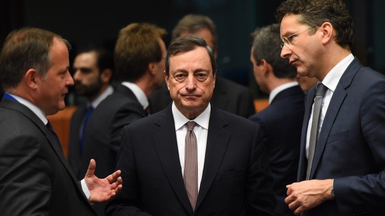 Eurogroup President and Dutch Finance Minister Jeroen Dijsselbloem (R) speaks before European Central Bank President Mario Draghi (C) on March 9, 2015 during a meeting of Eurogroup finance ministers at EU headquarters in Brussels. European finance ministers urged Greece to stop wasting time in talks on its crucial bailout as debt-stricken Athens warned of a possible referendum if its reform plans are rejected. Dijsselbloem said Greece had to make concrete progress if it wanted financial aid to be extended through the summer. Greek Finance Minister Yaris Varoufakis was presenting Athens's latest plans for reforms at the meeting in Brussels, which among other steps include using tourists as amateur sleuths to crack down on tax dodgers. AFP PHOTO / EMMANUEL DUNAND (Photo credit should read EMMANUEL DUNAND/AFP/Getty Images)