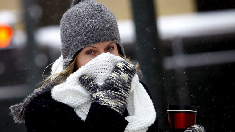 DETROIT, MI - JANUARY 6: A woman covers her face from the cold as the area deals with record breaking freezing weather January 6, 2014 in Detroit, Michigan. Michigan and most of the Midwest received their first major snow storm of 2014 last week and subzero temperatures are expected most of this week with wind-chill driving temperatures down to 50-70 degrees below zero. A "polar vortex" weather pattern is bringing some of the coldest weather the U.S. has had in almost 20 years. (Photo by Joshua Lott/Getty Images)