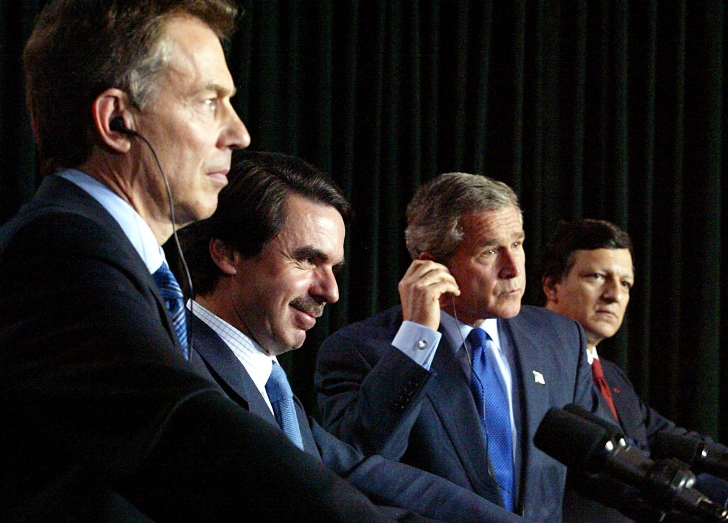 (L-R) Britain's Prime Minister Tony Blair, Spanish Prime Minister Jose Maria Aznar, US President George W. Bush and Portuguese Prime Minister Jose Manuel Durao Barosso listen at their joint press conference following meetings to discuss prospects for resolving the Iraq situation peacefully with diplomacy in final pursuit of a United Nations resolution 16 March, 2003, at Lajes Field on the island of Terceira in the Azores, Portugal. The four leaders, all facing anti-war opposition of varying degrees at home are the sponsors of a UN resolution that would set the stage for war on Iraq. (Photo by Luke FRAZZA/AFP/Getty Images)