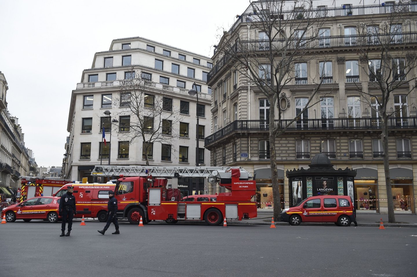 French police officers stand guard next to fire trucks parked near the Ritz Hotel in Paris after a fire broke out at the landmark hotel on January 19, 2016. A major fire broke out at the landmark Paris Ritz hotel, which is closed for renovations, the fire service said. The blaze is on the "top floor of the building and the roof", a fire service spokesman said. AFP PHOTO / LIONEL BONAVENTURE / AFP / LIONEL BONAVENTURE (Photo credit should read LIONEL BONAVENTURE/AFP/Getty Images)