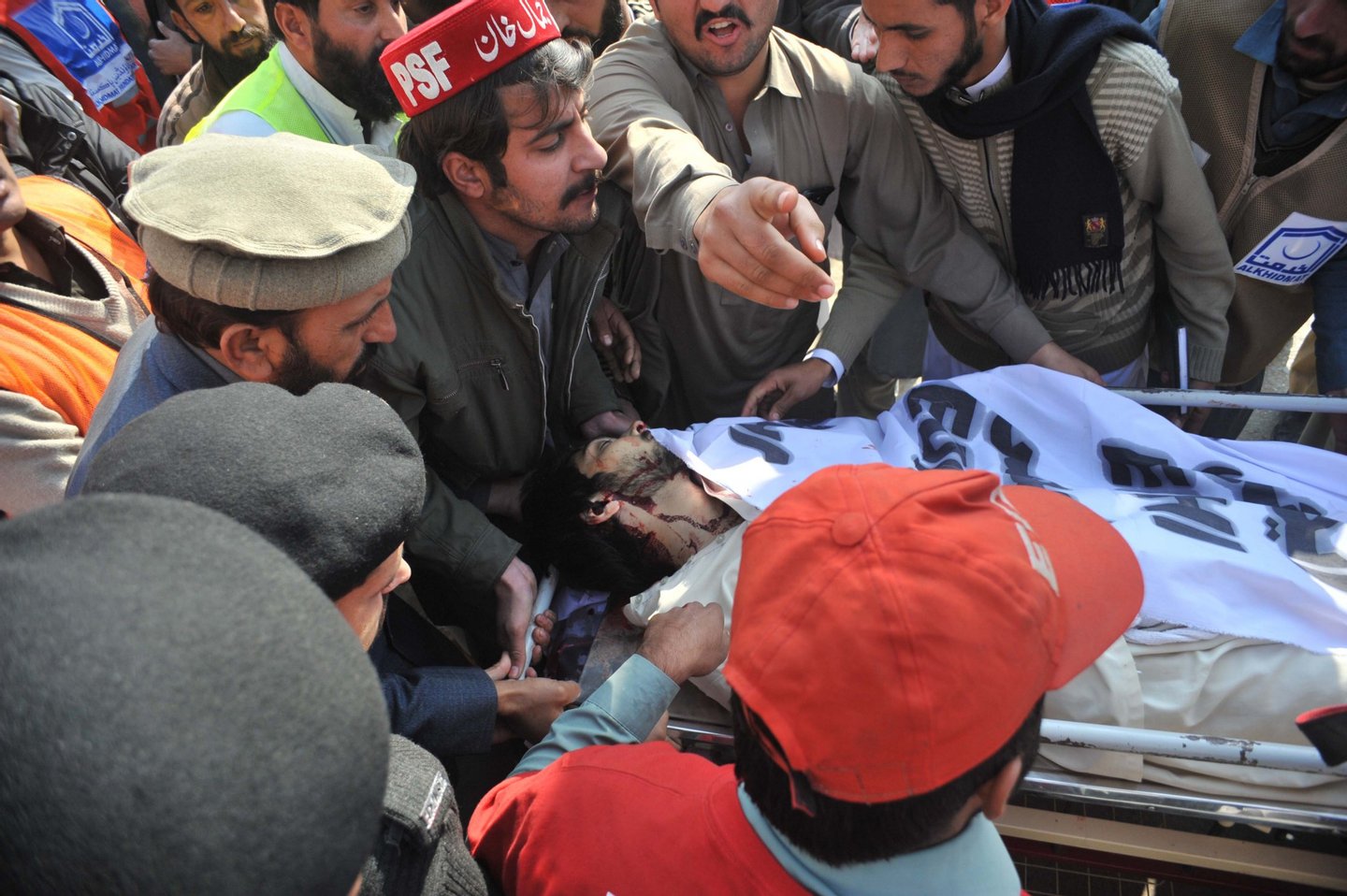 Pakistani rescue workers carry an injured student on arrival at a hospital following an attack by gunmen at Bacha Khan university in Charsadda, about 50 kilometres from Peshawar, on January 20, 2016. At least 21 people died in an armed assault on a university in Pakistan on January 20, where witnesses reported two large explosions as security forces moved in under dense fog to halt the bloodshed. AFP PHOTO / Hasham AHMED / AFP / HASHAM AHMED (Photo credit should read HASHAM AHMED/AFP/Getty Images)
