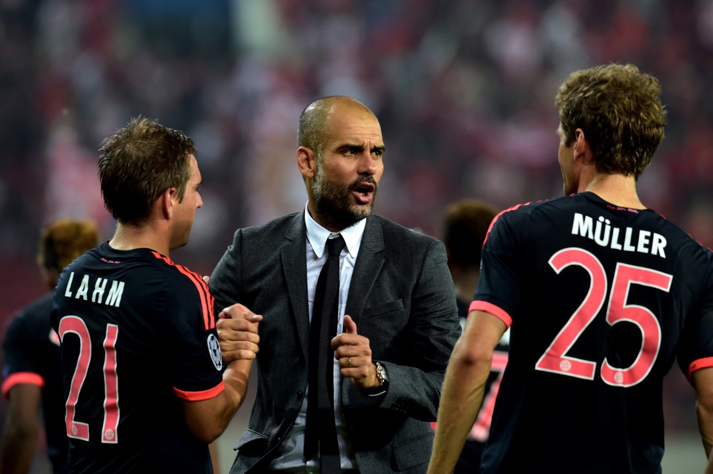 Bayern Munich's Spanish coach Josep Guardiola (C) speaks with Bayern Munich's German forward Thomas Mueller (R) after his team won against Olympiakos during the Group F Champions League football match at the Karaiskaki stadium in Athens on September 16, 2015. AFP PHOTO / ARIS MESSINIS (Photo credit should read ARIS MESSINIS/AFP/Getty Images)