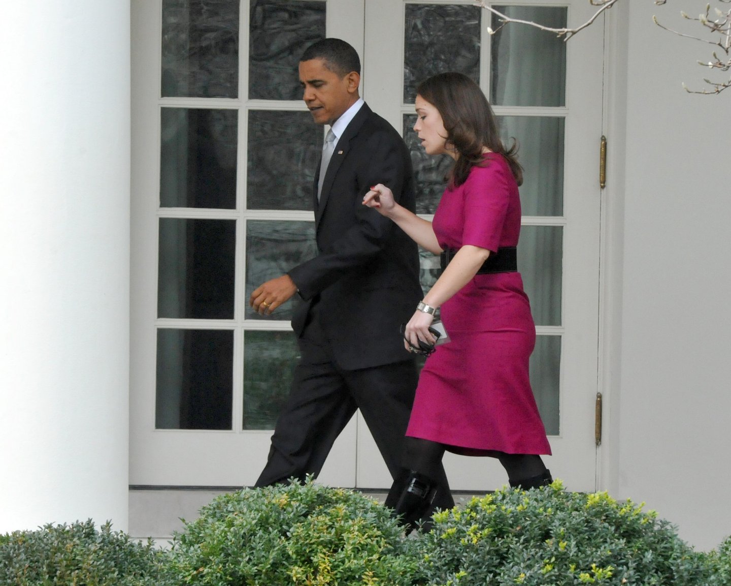 WASHINGTON - DECEMBER 15: U.S. President Barack Obama (L) walks on the Colonnade to the Oval Office walks on the Colonnade to the Oval Office with his personal secretary Katie Johnson after he returned to the White House from an appearance at a Home Depot December 15, 2009 in Alexandria, Virginia. Obama is imploring congress to pass new homeowner incentives to make their homes more energy efficient. (Photo by Ron Sachs-Pool/Getty Images)