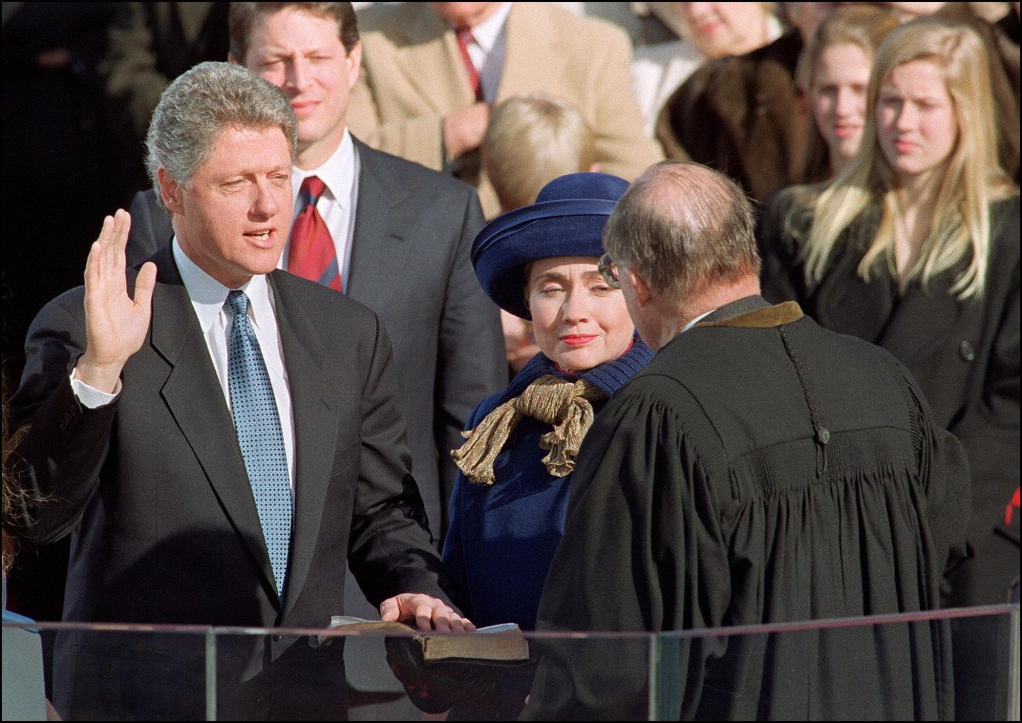WASHINGTON, : US President William Jefferson Clinton in a picture taken 20 January 1993 in Washington, DC, takes the oath of office from Chief Justice of the Supreme Court William Rehnquist to become the 42nd President of the US as his wife Hillary Rodham Clinton looks on. (Photo credit should read TIM CLARY/AFP/Getty Images)