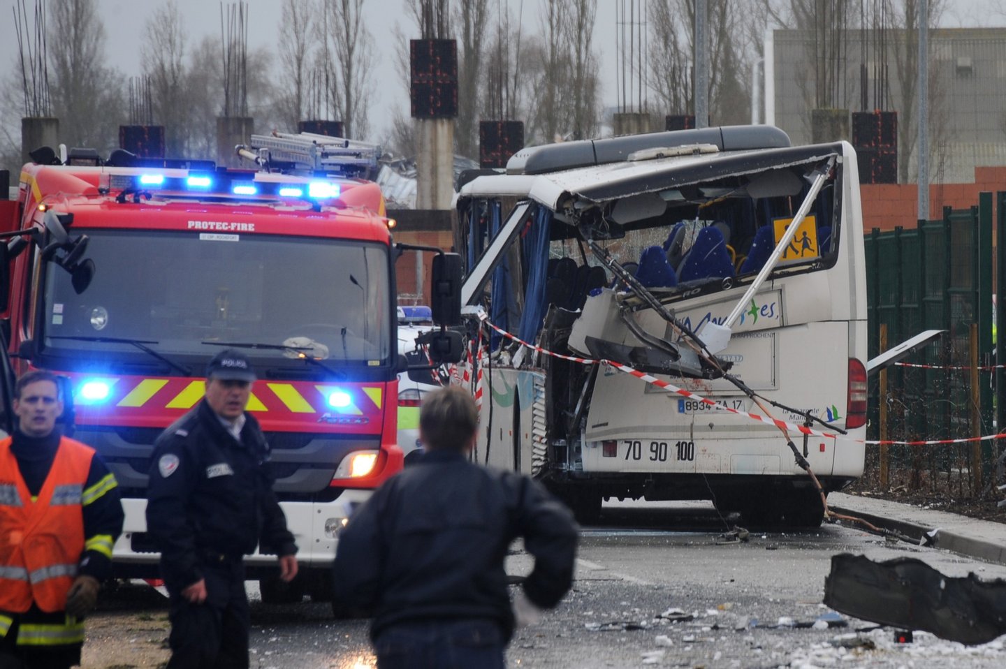 A French police officer stands near the wreckage of a school minibus after it crashed into a truck near Rochefort on February 11, 2016, killing at least six children, police said, a day after another road accident involving a school bus left two youngsters dead. The head-on smash with a lorry carrying rubble came around 7:15 am (0615 GMT) near Rochefort in the western Charente-Maritime region. / AFP / XAVIER LEOTY (Photo credit should read XAVIER LEOTY/AFP/Getty Images)
