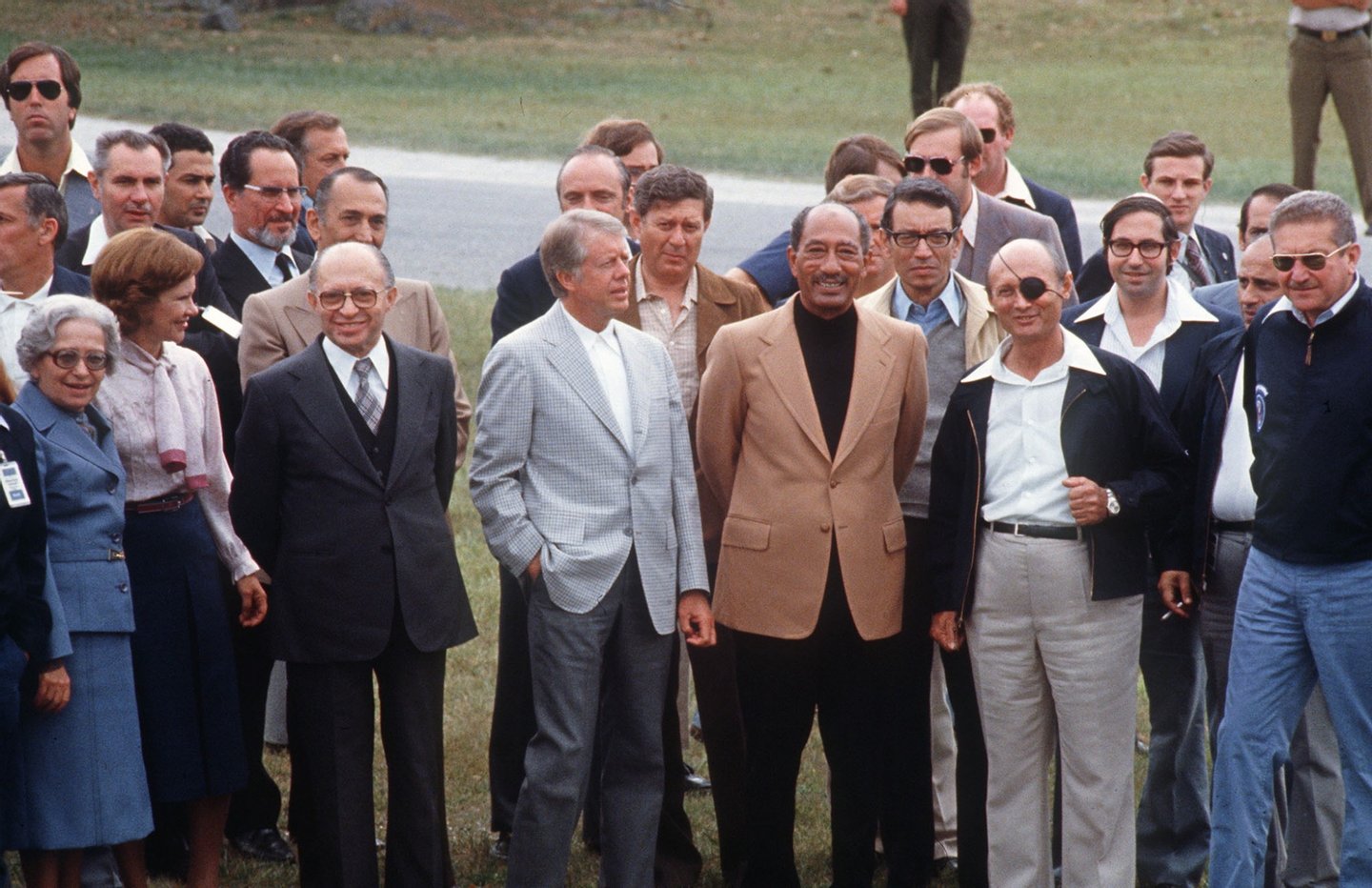 GETTYSBURG, UNITED STATES: Egyptian President Anwar al-Sadat (c) surrounded by (l-r) Aliza Begin, Rosalyn Carter, Israeli Premier Menachem Begin, US President Jimmy Carter, Israeli Foreign minister Moshe Dayan and Israeli Defence minister Ezer Weizman as they walk 10 September 1978 in Gettysburg during the Camp David Israeli-Egyptian peace negotiations. Boutros Boutros-Ghali, minister of state in Egypt's foreign ministry is standing between Sadat and Dayan and Elyahu Rubinstein, an Israeli advisor, is standing between Dayan and Weizman. Egypt began peace initiatives with Israel in late 1977, when Sadat visited Jerusalem. A year later, with the help of Carter, terms of peace between Egypt and Israel were negotiated at Camp David. A formal treaty, signed 26 March 1979 in Washington, D.C., granted full recognition of Israel by Egypt, opened trade relations between the two countries, and limited Egyptian military buildup in the Sinai. Israel agreed to return to final portion of occupied Sinai to Egypt. (Photo credit should read AFP/AFP/Getty Images)