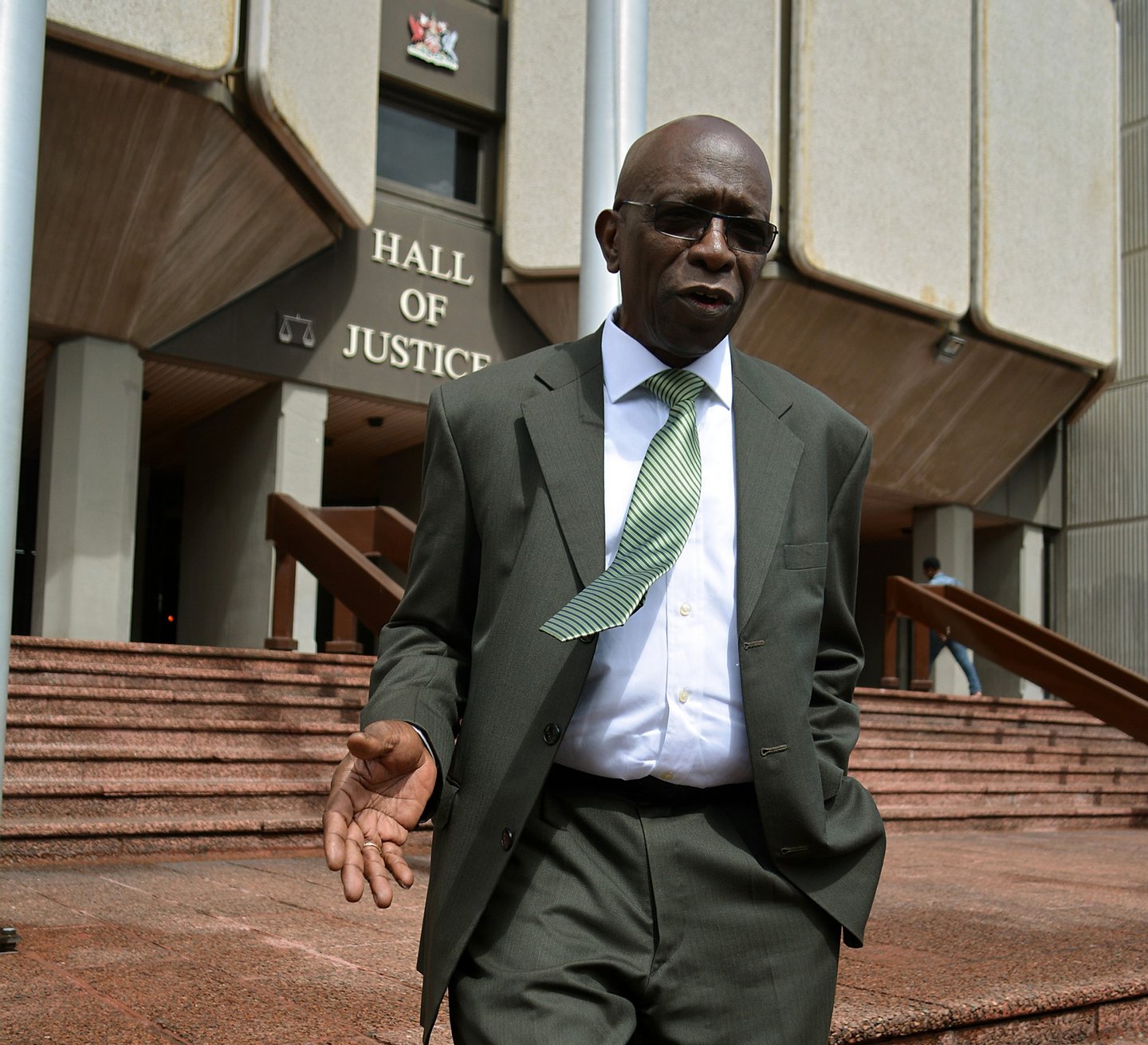 Former FIFA vice-president Jack Warner talks with journalists outside the Hall of Justice in Port-of-Spain, Trinidad, on December 4, 2015, following the hearing of his legal challenge to avert being extradited to the United States where he has been indicted on bribery, racketeering and money laundering charges. AFP photo/ALVA VIARRUEL / AFP / ALVA VIARRUEL (Photo credit should read ALVA VIARRUEL/AFP/Getty Images)