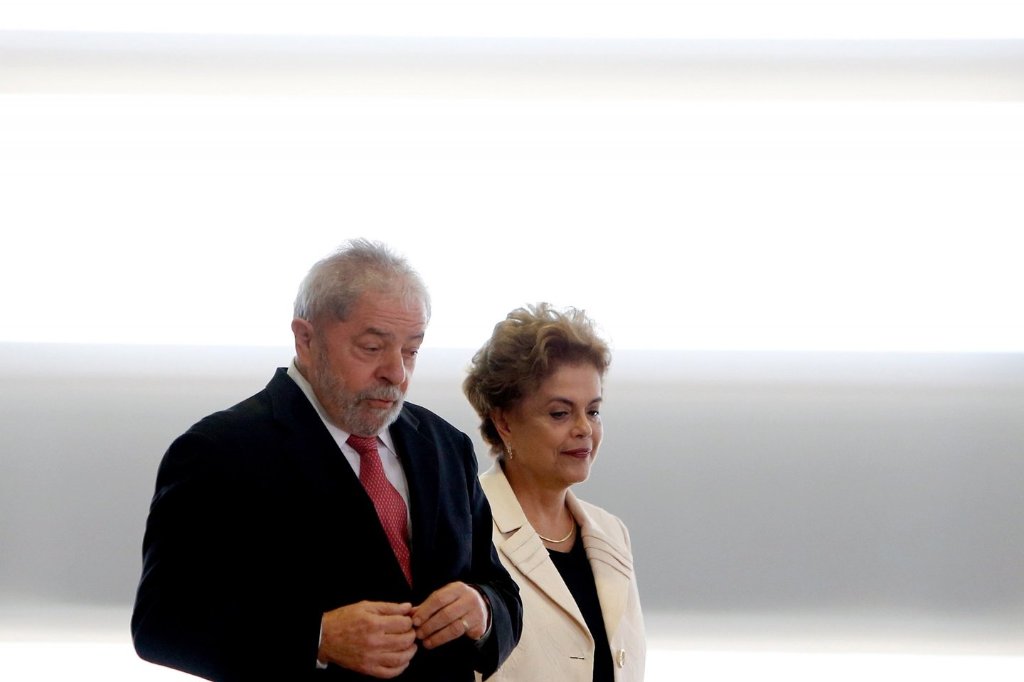 BRASILIA, BRAZIL - MARCH 17: Brazil's former president, Luiz Inacio Lula da Silva (L) walks with President Dilma Rousseff as he is sworn in as the new chief of staff in the Planalto Palace on March 17, 2016 in Brasilia, Brazil. His controversial cabinet appointment comes in the wake of a massive corruption scandal and economic recession in Brazil. (Photo by Igo Estrela/Getty Images)