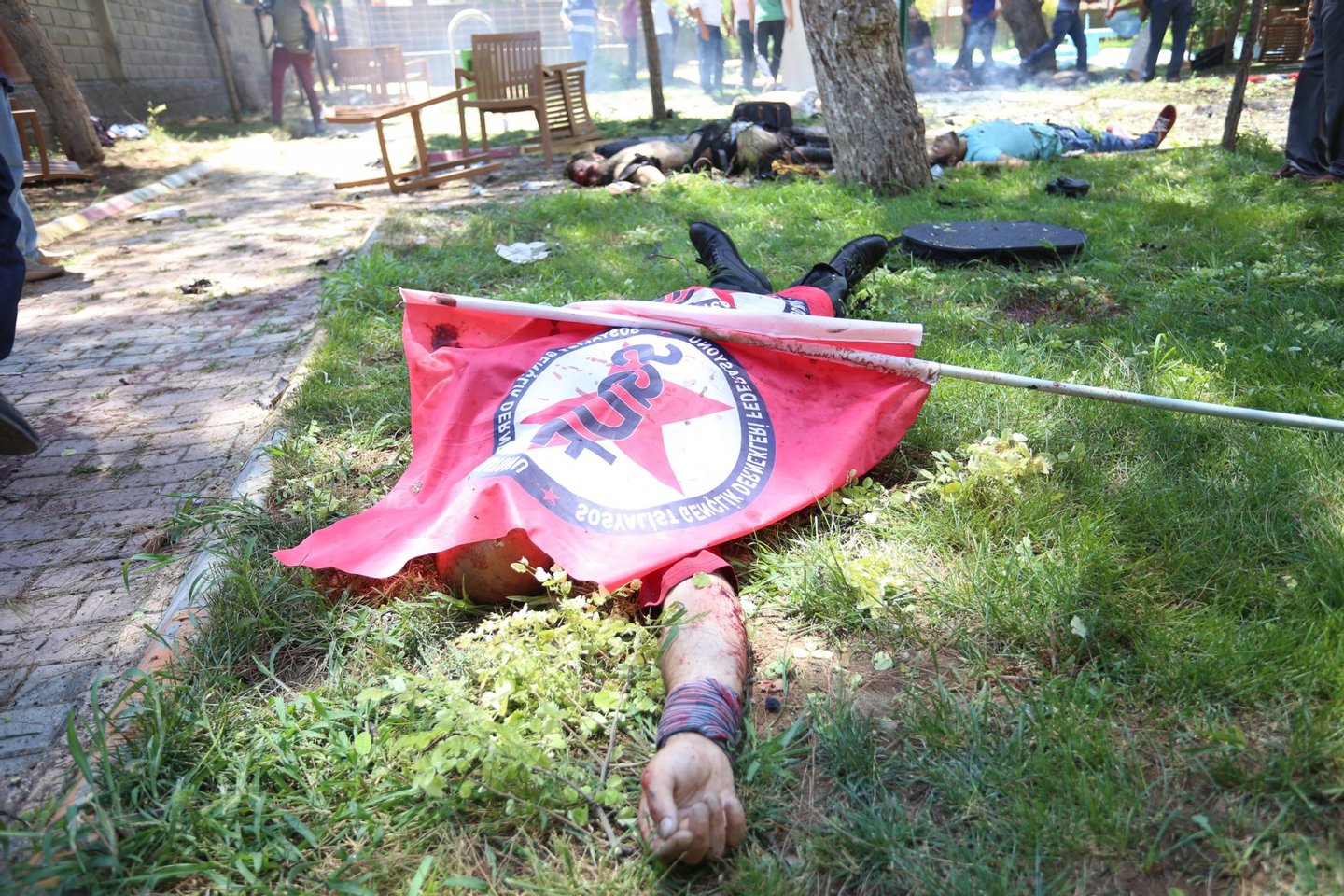 This photo taken on July 20, 2015 shows bodies on the ground after an explosion in the town of Suruc, on July 20, 2015, not far from the Syrian border. At least 20 people were killed and dozens injured, with the origin of the explosion not immediately determined, but many authorities and Turkish media claiming the attack to be carried out by a suicide bomber. AFP PHOTO / TURKEY OUT / OZCAN SOYSAL / DEPO PHOTOS        (Photo credit should read DEPO PHOTOS/AFP/Getty Images)