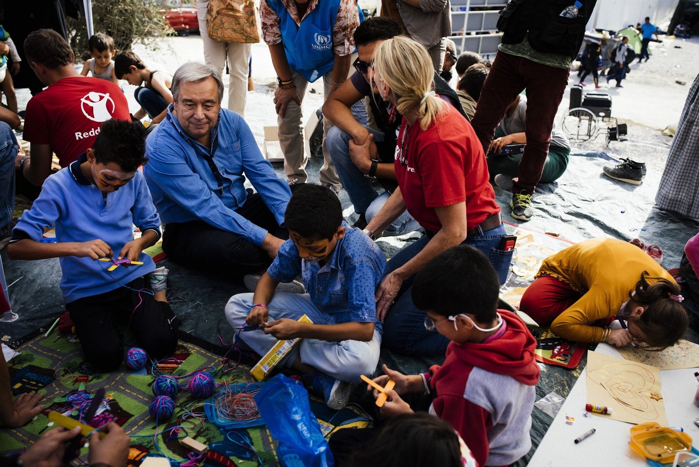 UNHCR commissioner Antonio Guterres (C) meets with migrant children during his visit to the Moria Identification Center on the Greek island of Lesbos on October 10, 2015. Greece was hit by a huge new surge in migrants as the United Nations on October 9 approved a European seize-and-destroy military operation against people smugglers in the Mediterranean. AFP PHOTO / DIMITAR DILKOFF (Photo credit should read DIMITAR DILKOFF/AFP/Getty Images)