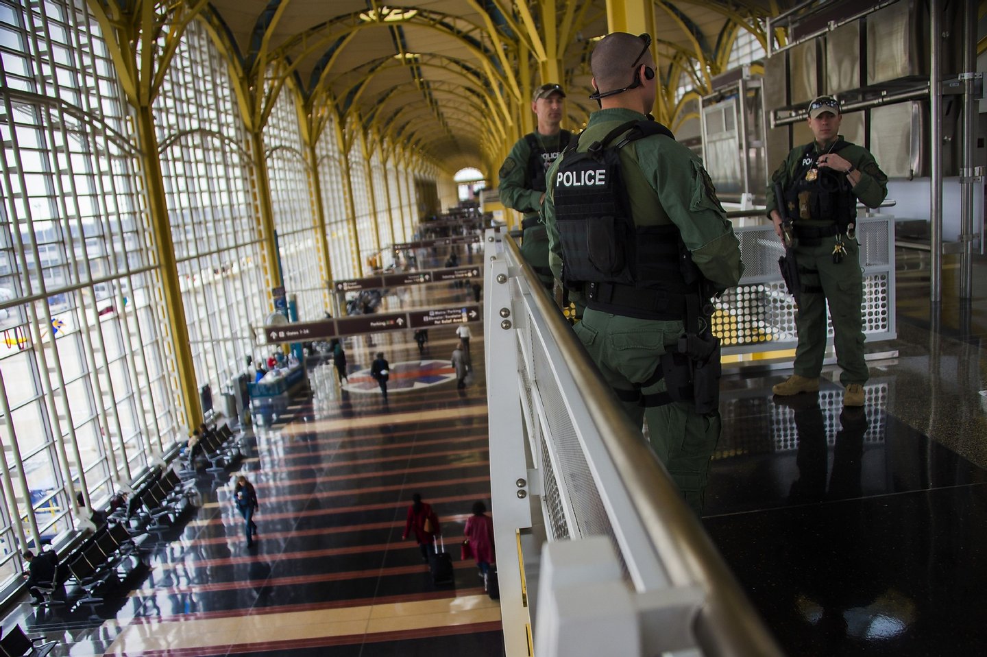 Heavily armed police patrol Ronald Reagan Washington National Airport in Arlington, Virginia, March 22, 2016. New York and Washington stepped up security in the wake of the attacks in Brussels on March 22, deploying counter-terrorism reinforcements and the National Guard to airports and stations, officials said. / AFP / Jim Watson (Photo credit should read JIM WATSON/AFP/Getty Images)
