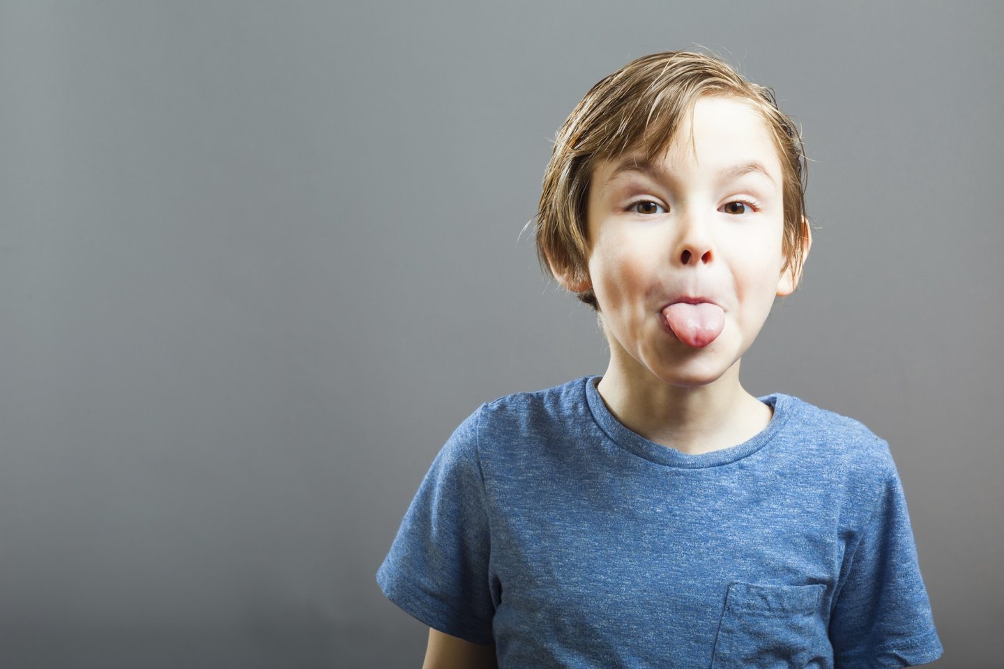 5 years, Gray, background, blue shirt, boy, child, copy space, cute, expression, face, fun, funny, grey, joking, kid, making faces, naughty, one, people, person, portrait, preschooler, sticking out, sticking out tongue, tongue, 