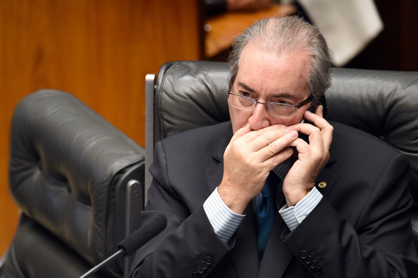 Eduardo Cunha, President of the Lower House of the Congress, speaks on a mobile phone during a session in Brasilia on April 16, 2016. Brazil's lower house of Congress opened debate Friday on impeachment of President Dilma Rousseff ahead of a vote this weekend that could seal her fate. Rousseff fought for her political life on Saturday, lobbying lawmakers to defeat a looming impeachment vote while lashing out at "corrupt" critics seeking to oust her. / AFP / EVARISTO SA (Photo credit should read EVARISTO SA/AFP/Getty Images)
