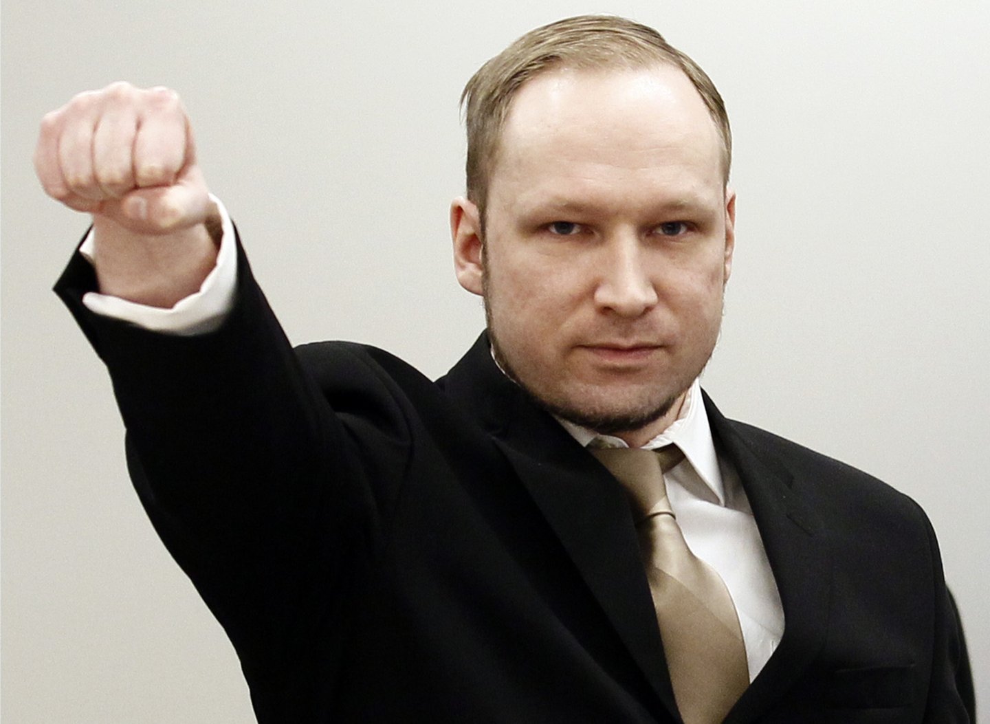 Rightwing extremist Anders Behring Breivik, who killed 77 people in twin attacks in Norway last year, makes a farright salute as he enters the Oslo district courtroom at the opening of his trial on April 16, 2012. Breivik told the Court that he did not recognise its legitimacy. Since Breivik has already confessed to the deadliest attacks in post-war Norway, the main line of questioning will revolve around whether he is criminally sane and accountable for his actions, which will determine if he is to be sentenced to prison or a closed psychiatric ward. AFP PHOTO / POOL / HEIKO JUNGE / AFP / POOL / HEIKO JUNGE (Photo credit should read HEIKO JUNGE/AFP/Getty Images)