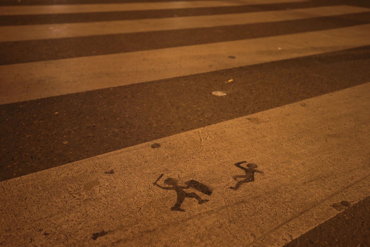 A stencil is sprayed onto a zebra crossing close to the Place de la Republique in Paris where the Nuit Debout, or "Up All Night" movement have been rallying against the French government's proposed labour reforms on April 29, 2016. AFP PHOTO / JOEL SAGET / AFP / JOEL SAGET (Photo credit should read JOEL SAGET/AFP/Getty Images)