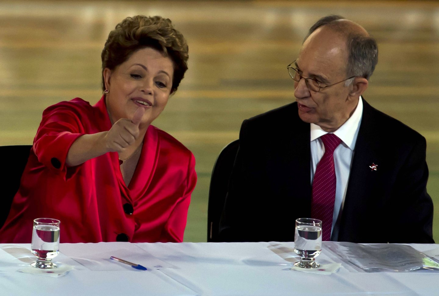 Brazilian President Dilma Rousseff (L) gestures next to Rui Falcao, president of the Workers Party (PT), during celebrations to mark the 34th anniversary of the founding of the Workers Party (PT) in Sao Paulo, Brazil on February 10, 2014. AFP PHOTO / NELSON ALMEIDA (Photo credit should read NELSON ALMEIDA/AFP/Getty Images)