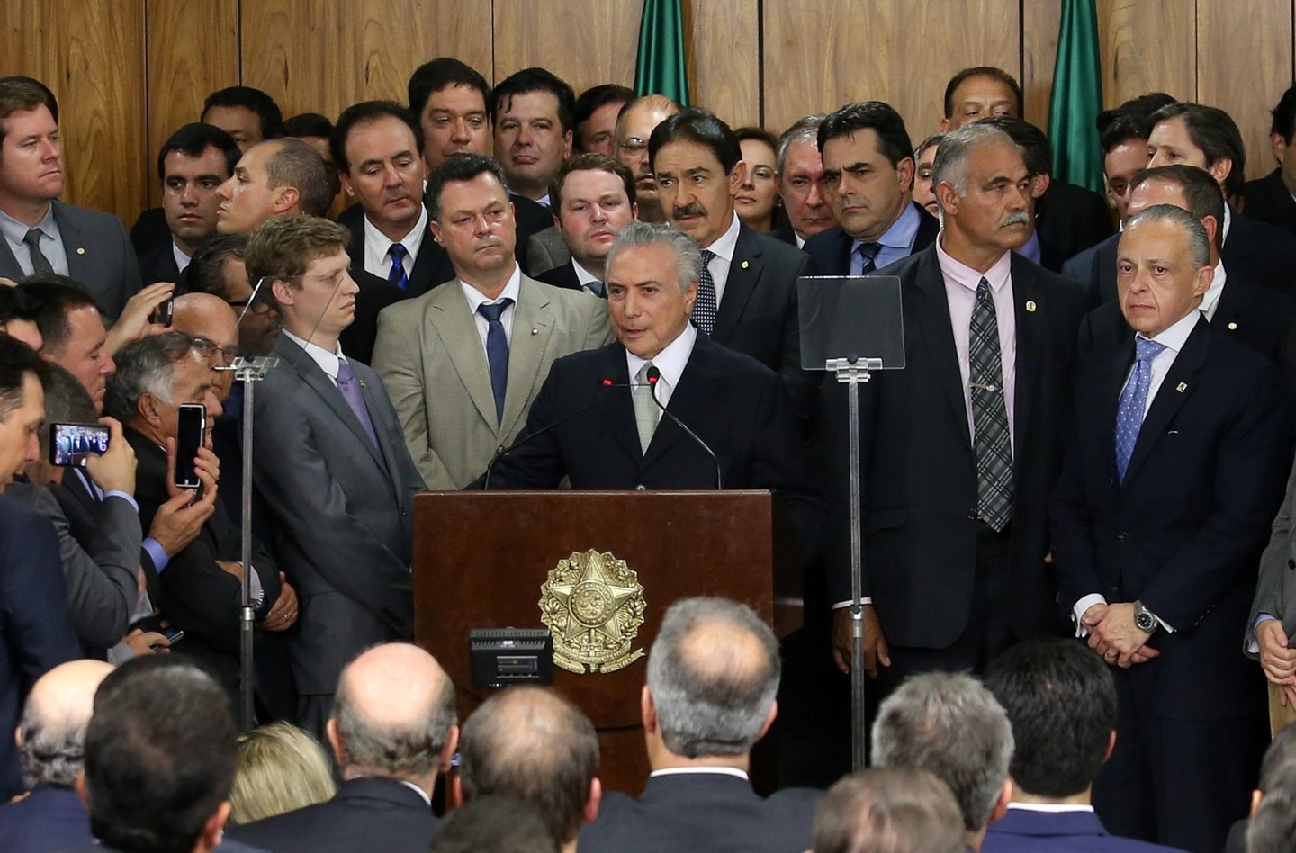 Michel Temer, Brazil's acting president, center, speaks during an event in Brasilia, Brazil, on Thursday, May 12, 2016. Temer has been the number two to President Dilma Rousseff of Brazil and now, with her temporary ouster, takes charge, buoyed by an almost evangelical market faith in him, as seen by the real's spike -- the world's best-performing currency this year -- and bond yield's plunge. It is widely expected that Rousseff will not return to power. Photographer: Lula Marques/Bloomberg via Getty Images