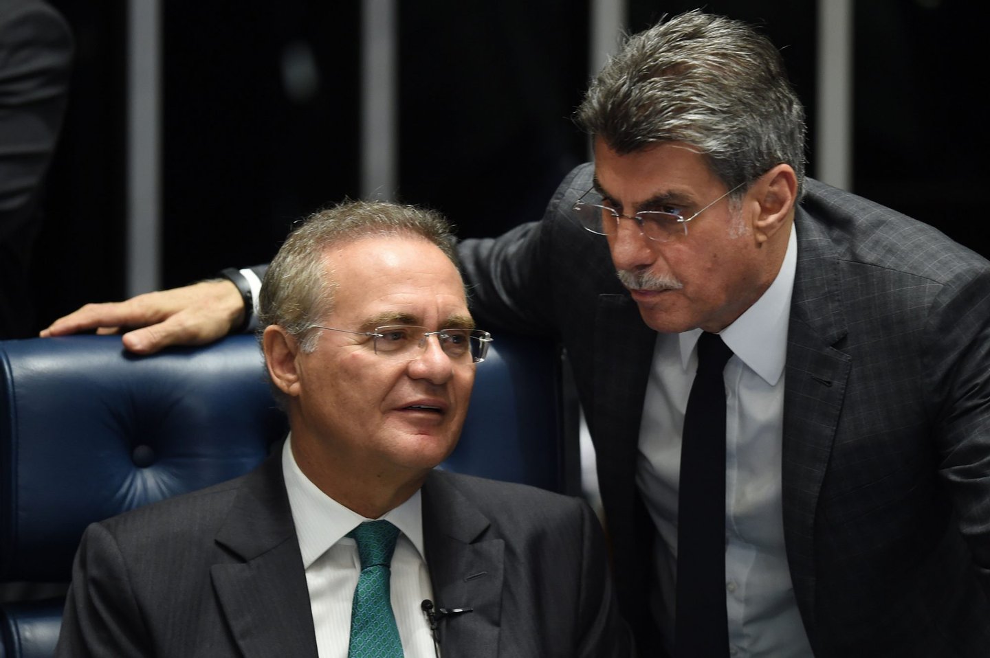 Senate President Renan Calheiros(L) and senator Romero Juca talk during debate Wednesday on suspending and impeaching President Dilma Rousseff in Brasilia on May 11, 2016. The Senate opened debate that could bring down the curtain on 13 years of leftist rule in Latin America's biggest country. Even allies of Rousseff, 68, said she had no chance of surviving the vote. / AFP / EVARISTO SA (Photo credit should read EVARISTO SA/AFP/Getty Images)
