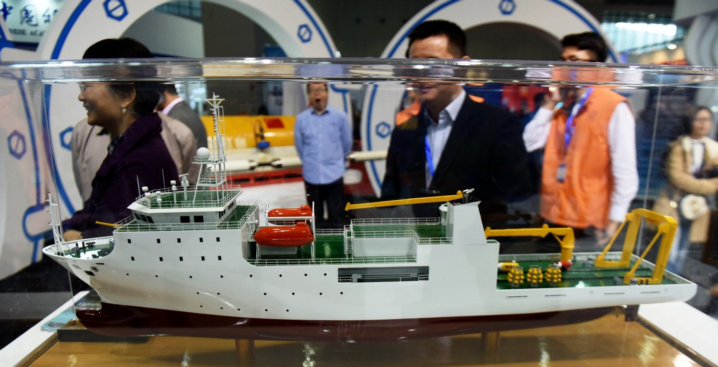 SHANGHAI, CHINA - NOVEMBER 03: (CHINA OUT) Visitors look at the model of ship "Zhang Qian", a mother vessel for China's first 11,000-meter manned submersible "Rainbow Fish", at the 17th China International Industry Fair at National Exhibition and Convention Center on November 3, 2015 in Shanghai, China. The 17th China International Industry Fair will open on Nov 3-7 at National Exhibition and Convention Center in Shanghai. (Photo by VCG/VCG via Getty Images)