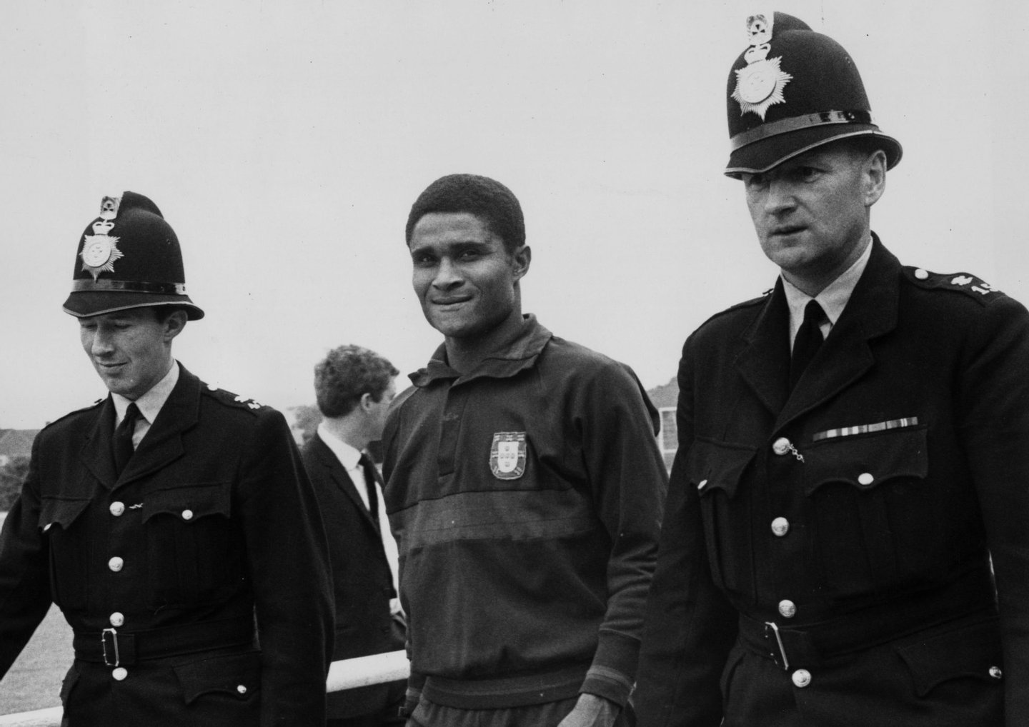 21st July 1966: Portuguese footballer, Eusebio, being escorted by two policemen to protect him from the autograph hunters who follow him everywhere. (Photo by Central Press/Getty Images)