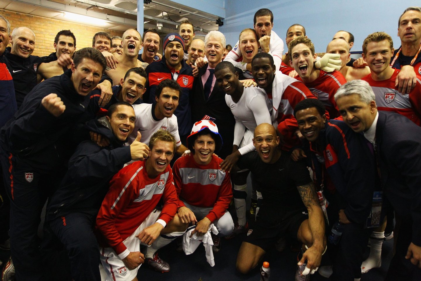 PRETORIA, SOUTH AFRICA - JUNE 23: Former US President Bill Clinton poses with jubilant US players in their dressing room after the 2010 FIFA World Cup South Africa Group C match between USA and Algeria at the Loftus Versfeld Stadium on June 23, 2010 in Tshwane/Pretoria, South Africa. (Photo by Jeff Mitchell - FIFA/FIFA via Getty Images)