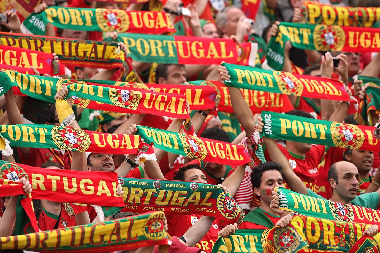 Frankfurt am Main, GERMANY: Portuguese supporters cheer their team prior to the World Cup 2006 group D football game Portugual vs.Iran 17 June 2006 at Frankfurt stadium. AFP PHOTO PATRIK STOLLARZ (Photo credit should read PATRIK STOLLARZ/AFP/Getty Images)