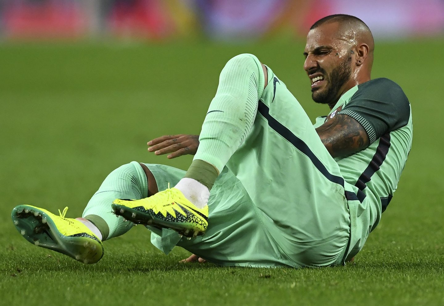 CORRECTION - Portugal's forward Ricardo Quaresma grimaces on the pitch after being takled during the friendly football match Portugal vs Norway at Dragao stadium in Porto on May 29, 2016, in preparation for the upcoming EURO 2016 tournament. / AFP / FRANCISCO LEONG / The erroneous mention[s] appearing in the metadata of this photo by FRANCISCO LEONG has been modified in AFP systems in the following manner: [on May 29, 2016] instead of [on May 28, 2016]. Please immediately remove the erroneous mention[s] from all your online services and delete it (them) from your servers. If you have been authorized by AFP to distribute it (them) to third parties, please ensure that the same actions are carried out by them. Failure to promptly comply with these instructions will entail liability on your part for any continued or post notification usage. Therefore we thank you very much for all your attention and prompt action. We are sorry for the inconvenience this notification may cause and remain at your disposal for any further information you may require.        (Photo credit should read FRANCISCO LEONG/AFP/Getty Images)