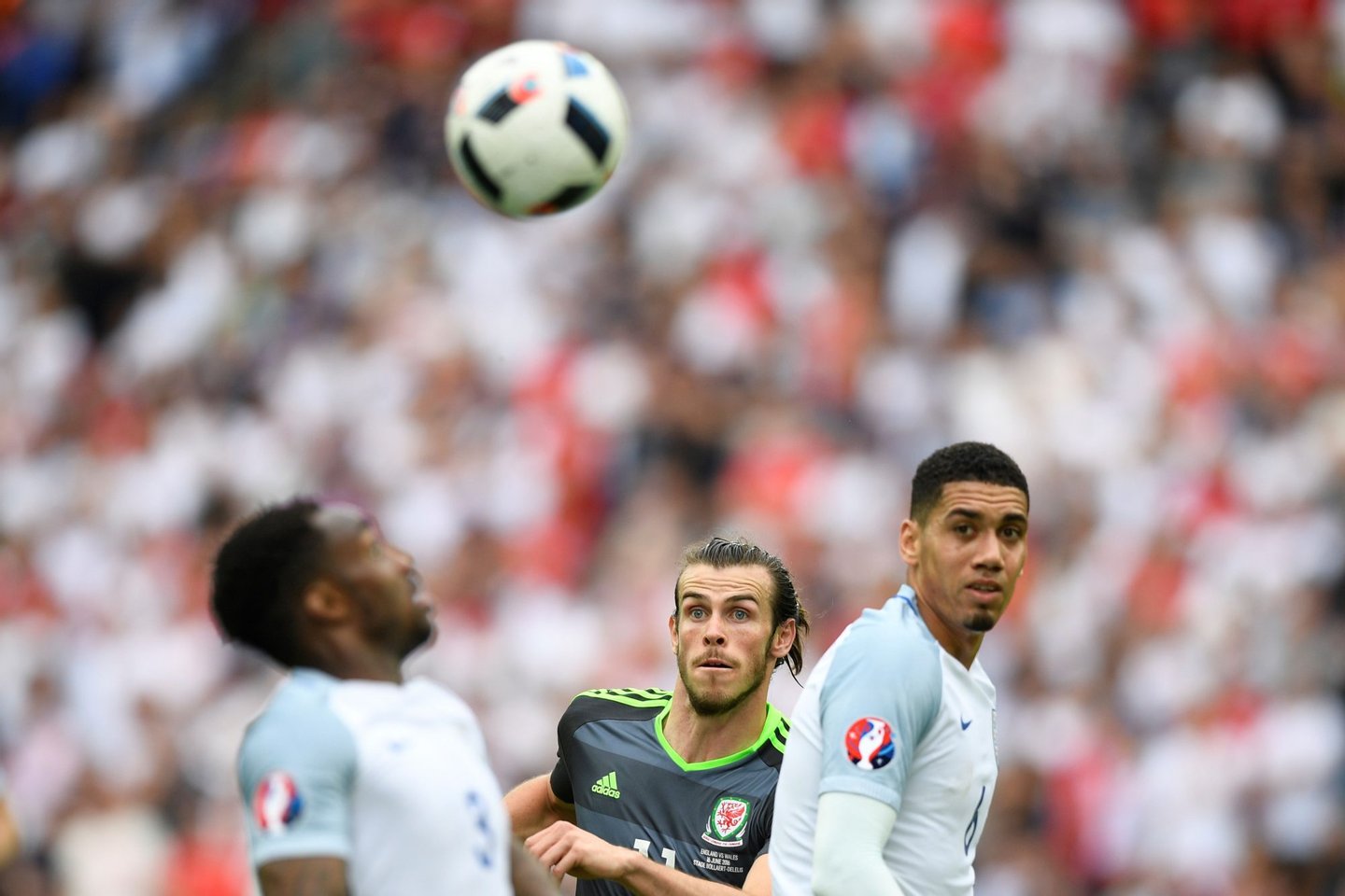 Wales' forward Gareth Bale (C) vies for the ball with England's defender Chris Smalling (R) and England's defender Danny Rose during the Euro 2016 group B football match between England and Wales at the Bollaert-Delelis stadium in Lens on June 16, 2016. / AFP / MARTIN BUREAU (Photo credit should read MARTIN BUREAU/AFP/Getty Images)