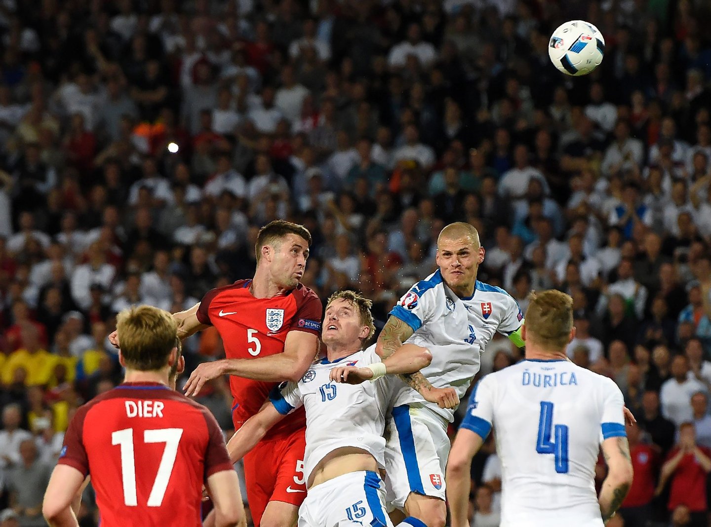 England's defender Gary Cahill (C-L) vies for the header with Slovakia's defender Tomas Hubocan (C) and Slovakia's defender Martin Skrtel (C-R) during the Euro 2016 group B football match between Slovakia and England at the Geoffroy-Guichard stadium in Saint-Etienne on June 20, 2016. / AFP / Joe KLAMAR (Photo credit should read JOE KLAMAR/AFP/Getty Images)