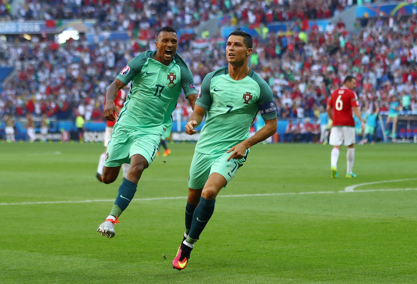 LYON, FRANCE - JUNE 22: Cristiano Ronaldo (R) of Portugal celebrates scoring his team's second goal with his team mate Nani (L) during the UEFA EURO 2016 Group F match between Hungary and Portugal at Stade des Lumieres on June 22, 2016 in Lyon, France. (Photo by Michael Steele/Getty Images)