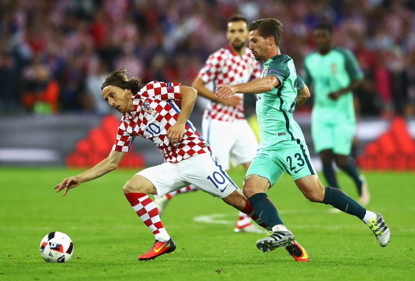 LENS, FRANCE - JUNE 25: Luka Modric of Croatia controls the ball under pressure of Adrien Silva of Portugal during the UEFA EURO 2016 round of 16 match between Croatia and Portugal at Stade Bollaert-Delelis on June 25, 2016 in Lens, France. (Photo by Clive Mason/Getty Images)