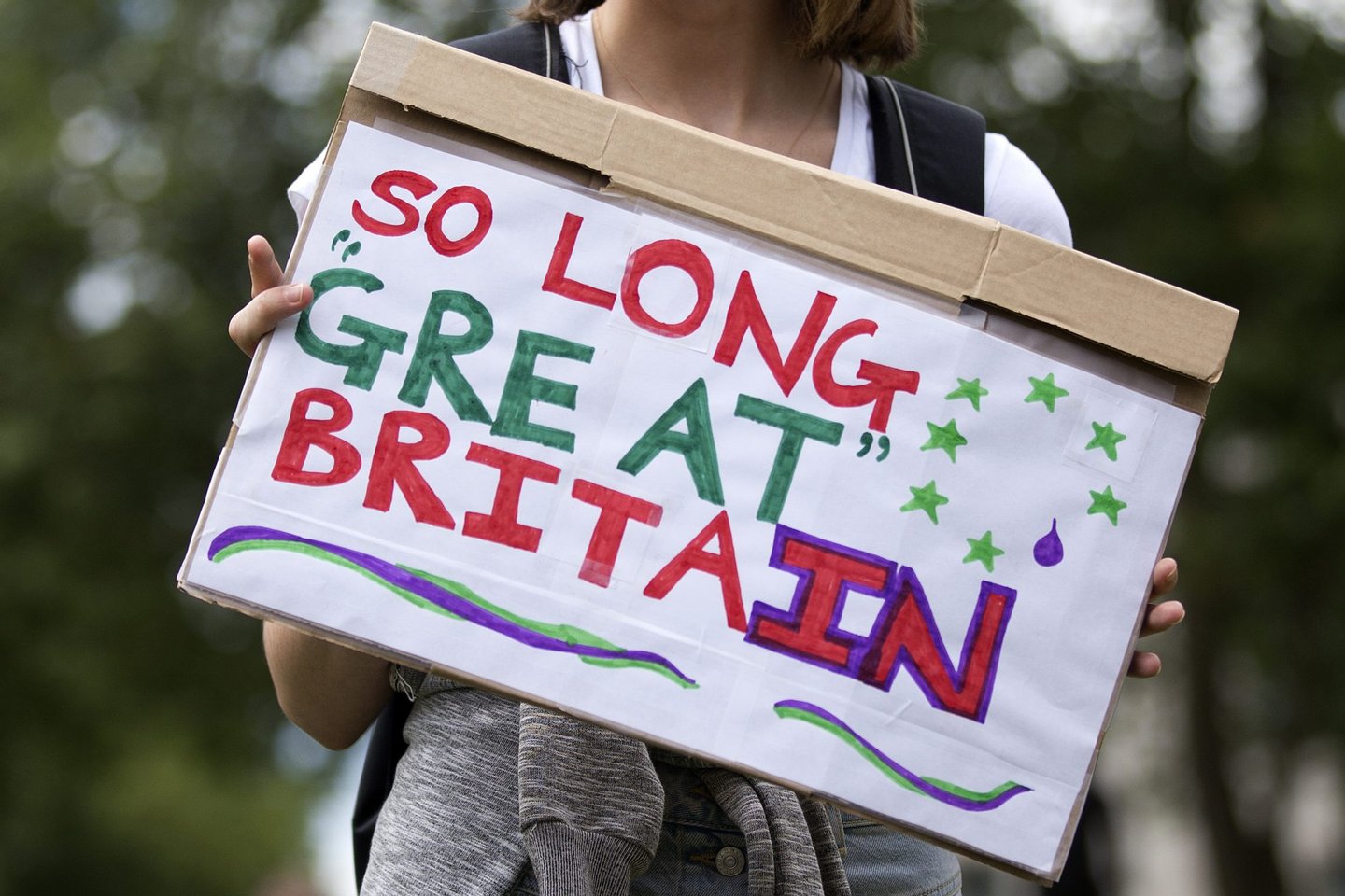 A demonstrator holds a placard that reads "So Long Great Britain" during a protest against the pro-Brexit outcome of the UK's June 23 referendum on the European Union (EU), in central London on June 25, 2016. The result of Britain's June 23 referendum vote to leave the European Union (EU) has pitted parents against children, cities against rural areas, north against south and university graduates against those with fewer qualifications. London, Scotland and Northern Ireland voted to remain in the EU but Wales and large swathes of England, particularly former industrial hubs in the north with many disaffected workers, backed a Brexit. / AFP / JUSTIN TALLIS (Photo credit should read JUSTIN TALLIS/AFP/Getty Images)