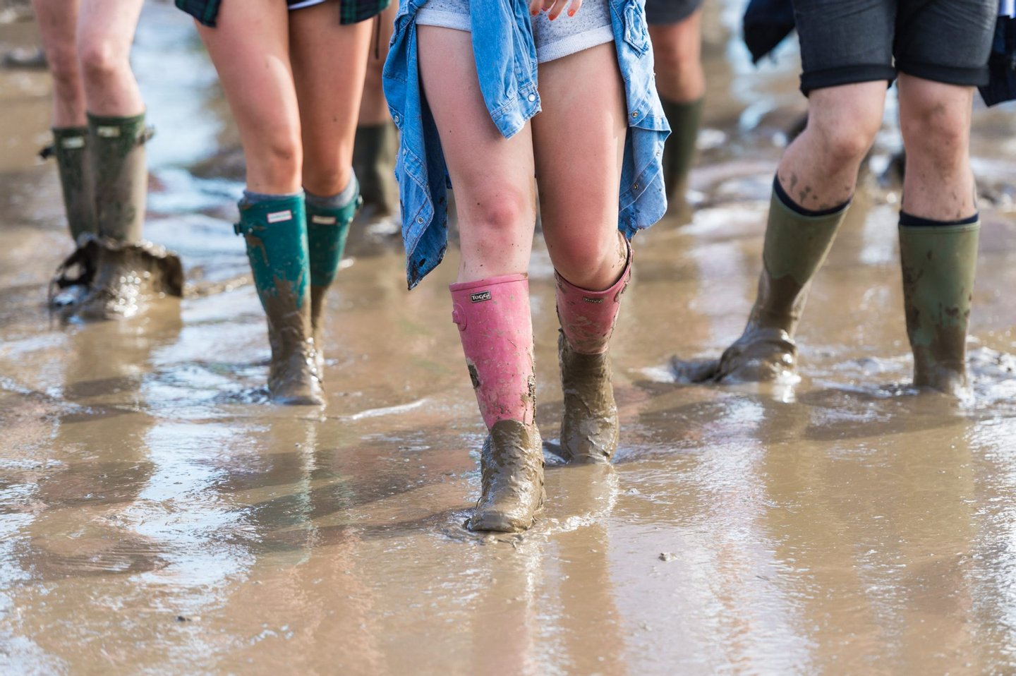 GLASTONBURY, ENGLAND - JUNE 22: Festival goers wade through the deep mud at the Glastonbury Festival at Worthy Farm, Pilton on June 22, 2016 in Glastonbury, England. Now its 46th year the festival is one largest music festivals in the world and this year features headline acts Muse, Adele and Coldplay. The Festival, which Michael Eavis started in 1970 when several hundred hippies paid just Â£1, now attracts more than 175,000 people. (Photo by Ian Gavan/Getty Images)