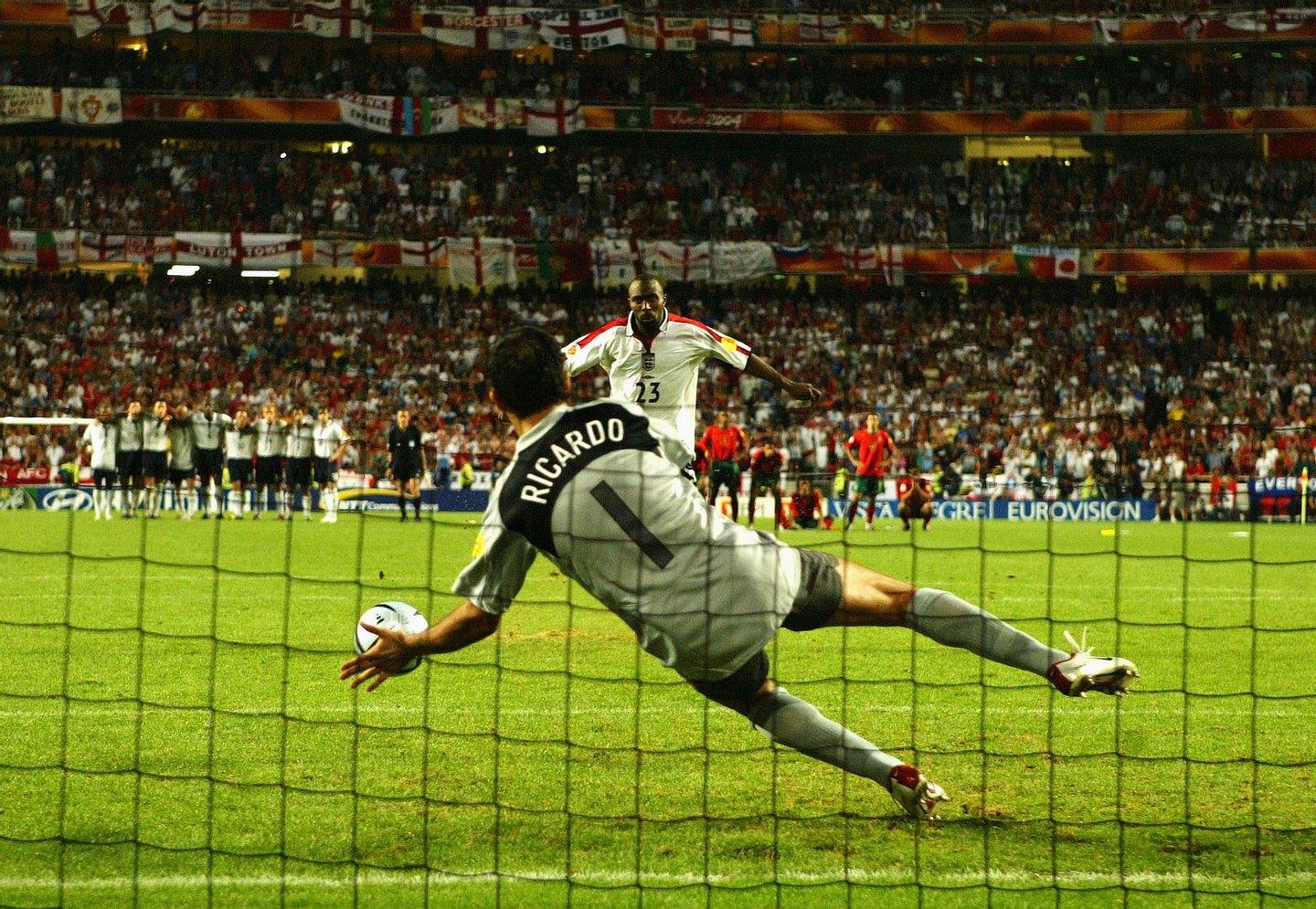 LISBON, PORTUGAL - JUNE 24: Darius Vassell of England has his penalty saved by goalkeeper Ricardo of Portugal during the UEFA Euro 2004 Quarter Final match between Portugal and England at the Luz Stadium on June 24, 2004 in Lisbon, Portugal. (Photo by Shaun Botterill/Getty Images)