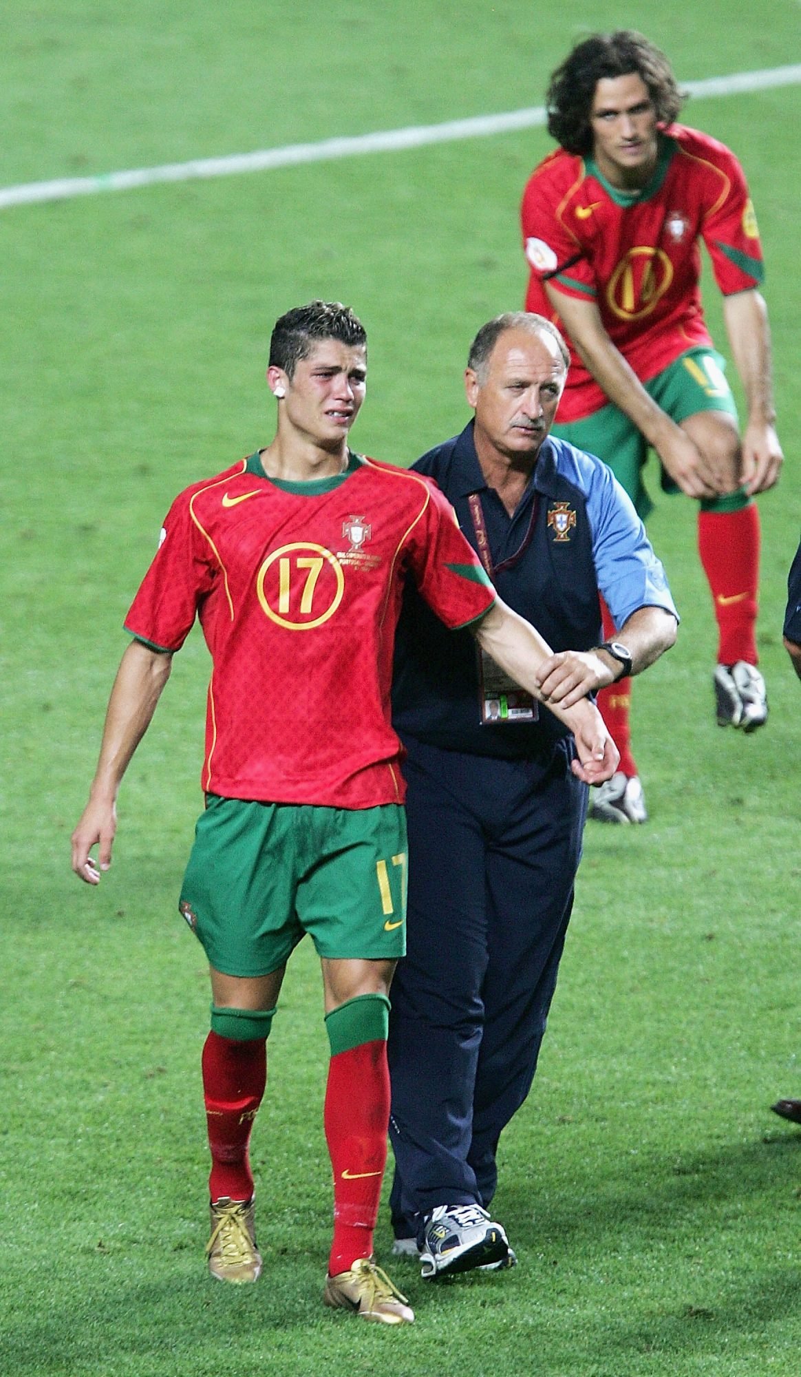LISBON, PORTUGAL - JULY 4: Cristiano Ronaldo of Portugal in tears with coach Luiz Felipe Scolari after the UEFA Euro 2004, Final match between Portugal and Greece at the Luz Stadium on July 4, 2004 in Lisbon, Portugal. (Photo by Laurence Griffiths/Getty Images)