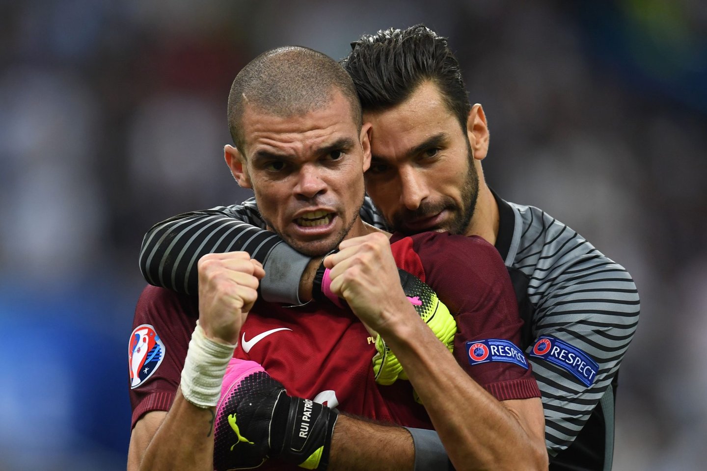 TOPSHOT - Portugal's defender Pepe (L) celebrates with Portugal's goalkeeper Rui Patricio during the Euro 2016 final football match between Portugal and France at the Stade de France in Saint-Denis, north of Paris, on July 10, 2016. / AFP / PATRIK STOLLARZ (Photo credit should read PATRIK STOLLARZ/AFP/Getty Images)