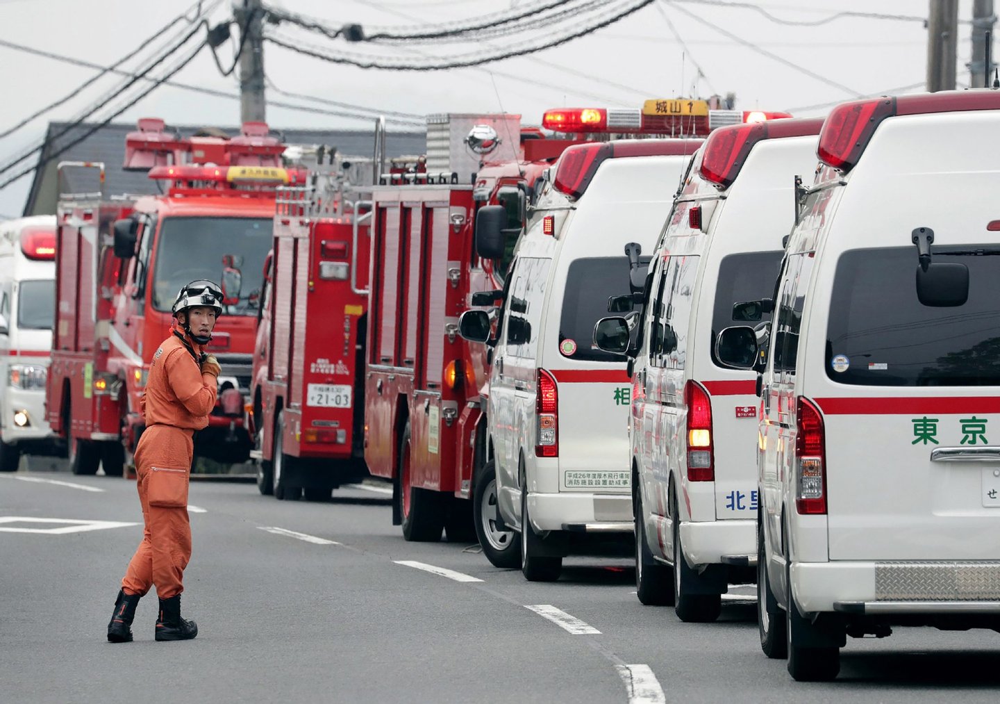 A rescue worker stands by beside ambulances near the Tsukui Yamayuri En care centre where a knife-wielding man went on a rampage in the city of Sagamihara, Kanagawa prefecture, some 50 kms (30 miles) west of Tokyo on July 26, 2016. At least 19 people were killed when the man went on a rampage at the care centre for the mentally disabled in Japan early on July 26, a fire official said. / AFP / JIJI PRESS / JIJI PRESS / Japan OUT (Photo credit should read JIJI PRESS/AFP/Getty Images)