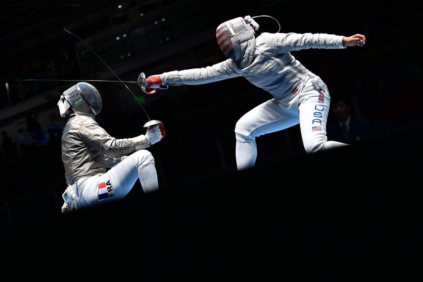 France's Cecilia Berder (L) competes against US Ibtihaj Muhammad during their womens individual sabre qualifying bout as part of the fencing event of the Rio 2016 Olympic Games, on August 8, 2016, at the Carioca Arena 3, in Rio de Janeiro. / AFP / Fabrice COFFRINI (Photo credit should read FABRICE COFFRINI/AFP/Getty Images)