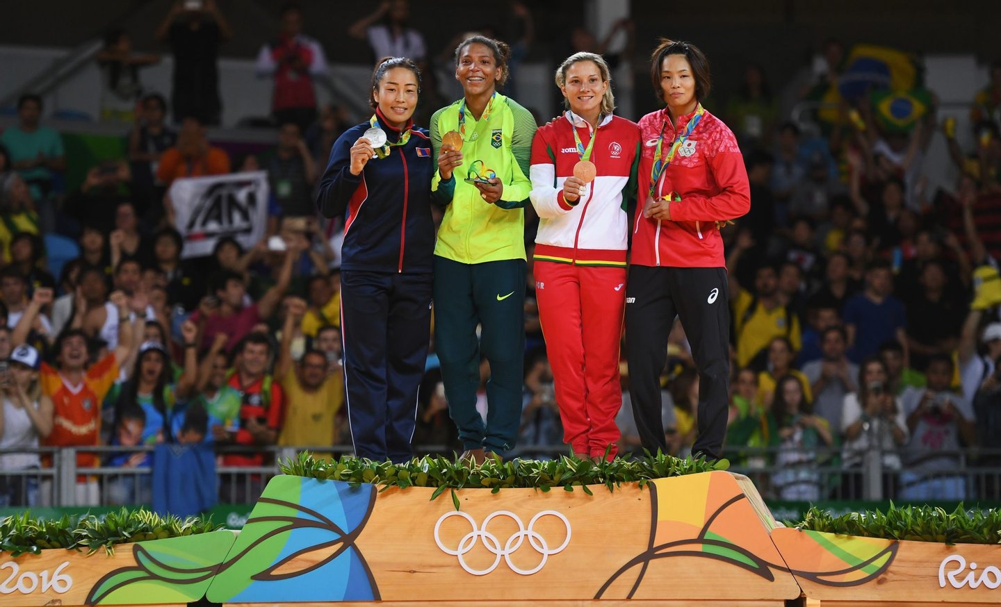 RIO DE JANEIRO, BRAZIL - AUGUST 08: Silver medalist Sumiya Dorjsuren of Mongolia, gold medalist Rafaela Silva of Brazil, bronze medalist Telma Monteiro of Portugal and bronze medalist Kaori Matsumoto of Japan celebrate on the podium after the Women's -57 kg Judo Contest on Day 3 of the Rio 2016 Olympic Games at Carioca Arena 2 on August 8, 2016 in Rio de Janeiro, Brazil. (Photo by David Ramos/Getty Images)