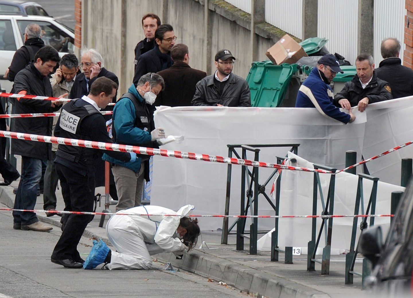 TO GO WITH AFP STORIES A YEAR AFTER MOHAMED MERAH CASE (FILES) - A photo taken on March 19, 2012 shows policemen working near the "Ozar Hatorah" Jewish school, in Toulouse, southwestern France, where four people (three of them children), were killed and two seriously wounded when a gunman opened fire. Mohamed Merah, a self-described Al-Qaeda sympathiser, shot a rabbi, three Jewish schoolchildren and three French paratroopers in attacks in and around the southern city of Toulouse in March 2012 before being shot dead in a police siege. AFP PHOTO / ERIC CABANIS (Photo credit should read ERIC CABANIS/AFP/Getty Images)
