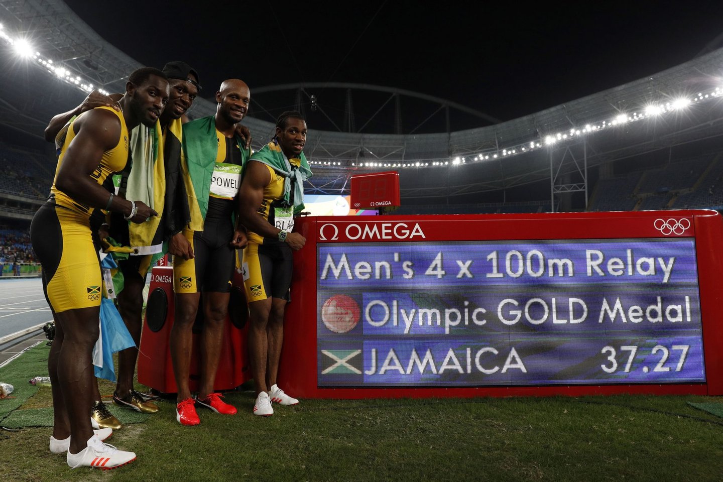 Team Jamaica (LtoR) Jamaica's Nickel Ashmeade, Jamaica's Usain Bolt, Jamaica's Asafa Powell and Jamaica's Yohan Blake celebrate after winning the Men's 4x100m Relay Final during the athletics event at the Rio 2016 Olympic Games at the Olympic Stadium in Rio de Janeiro on August 19, 2016. / AFP / Adrian DENNIS (Photo credit should read ADRIAN DENNIS/AFP/Getty Images)