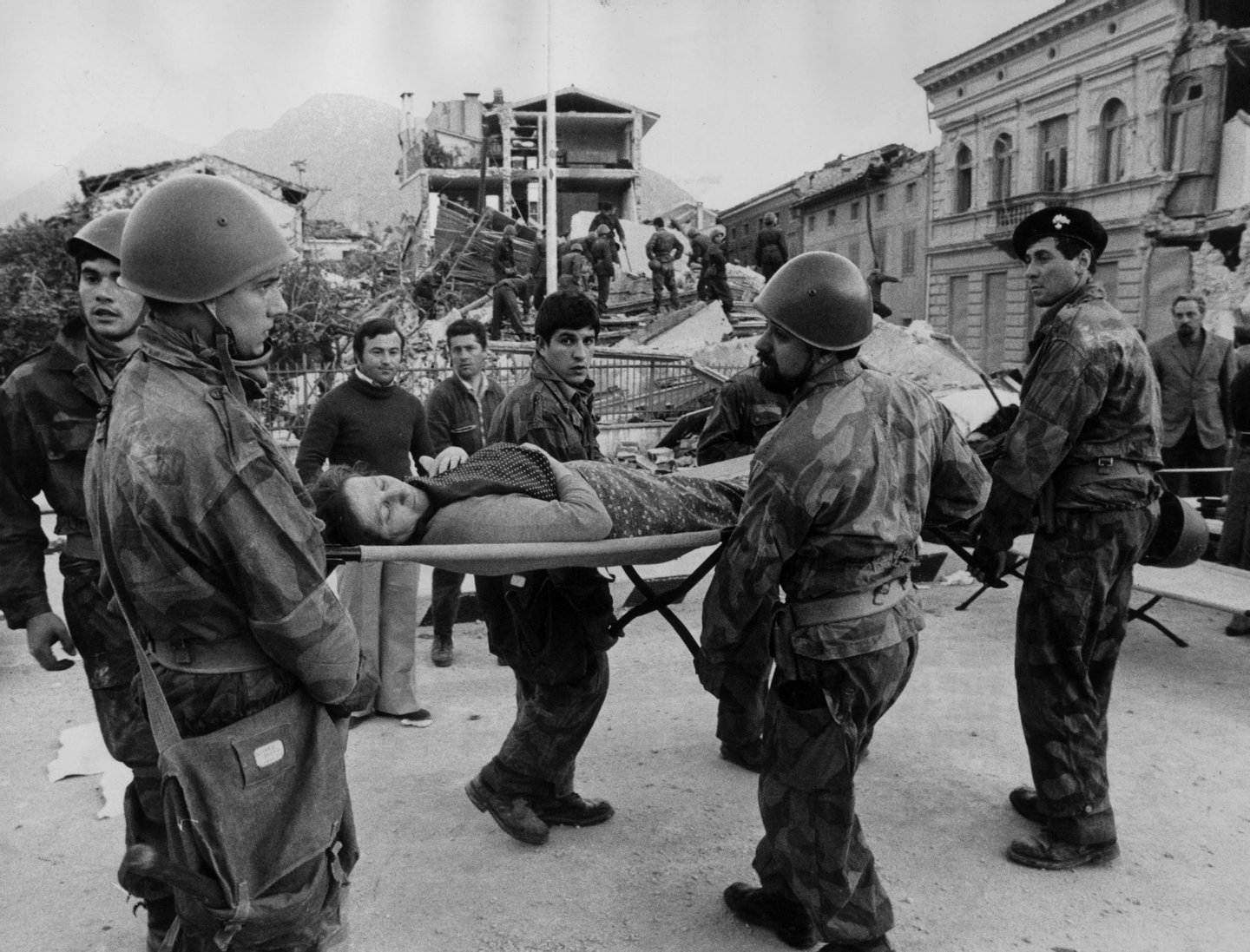 May 1976: Italian soldiers carry a woman on a stretcher to a place of safety after she was dug from the remains of her home after an earthquake in Udine which killed over a 1,000 people. (Photo by Livio Fioroni/Keystone/Getty Images)