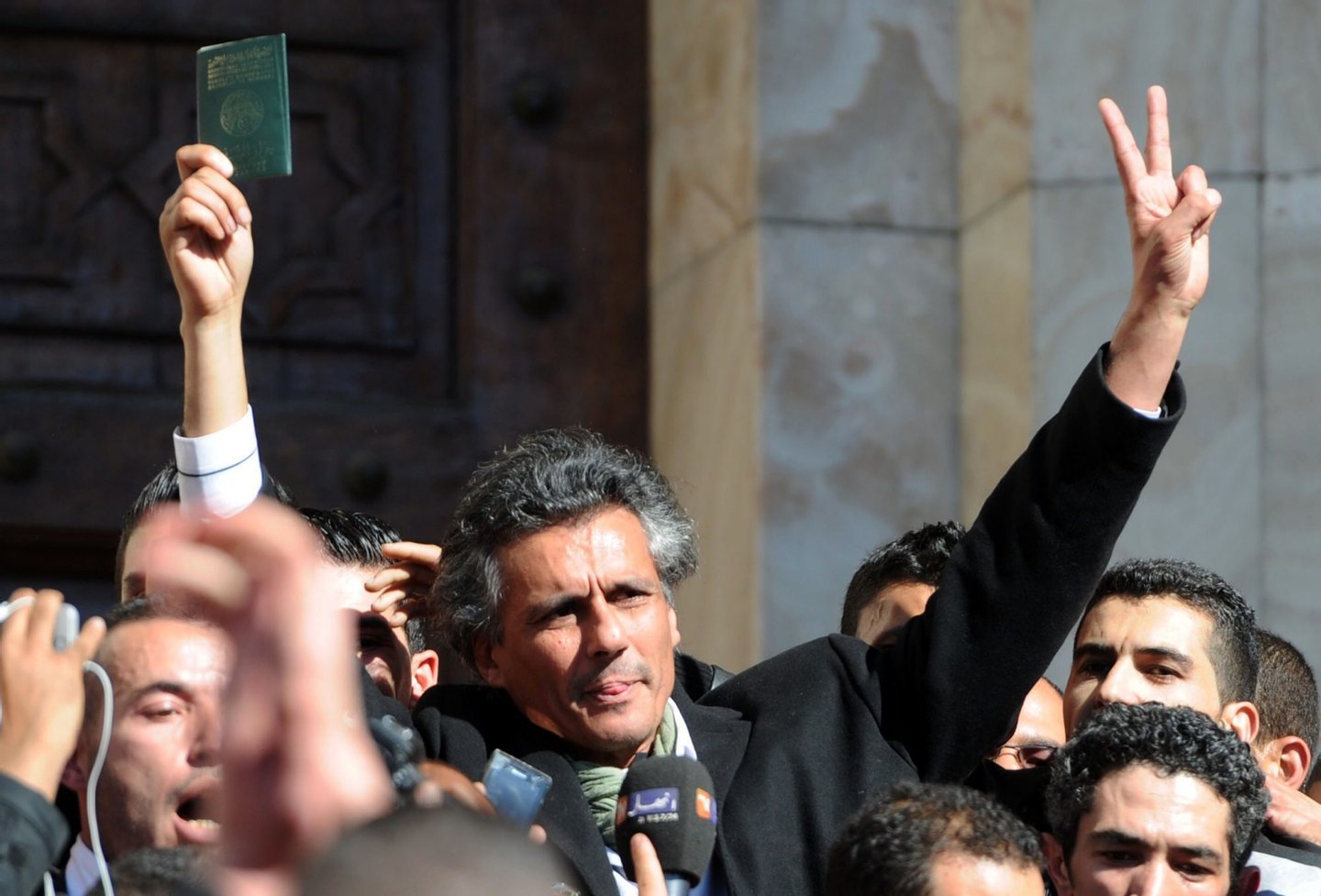 Rachid Nekkaz, who wanted to be candidate but couldn't register for Algeria's April 17 presidential election, flashes the sign of victory during a protest in his support in Algiers on March 8, 2014. Nekkaz said his candidature documents were stolen before he submits them at the constitutional council. AFP PHOTO / FAROUK BATICHE (Photo credit should read FAROUK BATICHE/AFP/Getty Images)