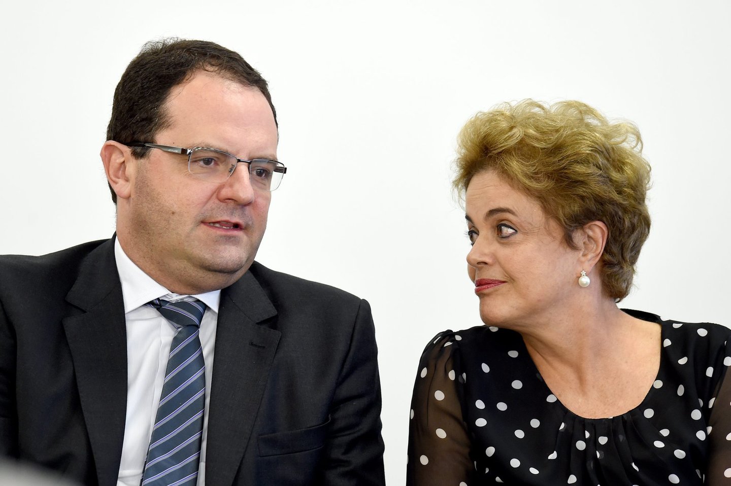 Brazilian President Dilma Rousseff (R) talks to her Finance Minister Nelson Barbosa during a ceremony to renovate the leasing contract regarding the use of the Paranagua Container Terminal, at Planalto Palace in Brasilia, on April 13, 2016. Brazil's President Dilma Rousseff vowed Wednesday she will "fight to the last minute" against efforts to impeach her, despite key allies deserting her as she clings to office. Lawmakers will hold a crucial vote on impeachment proceedings against Rousseff in congress on Sunday. / AFP / EVARISTO SA (Photo credit should read EVARISTO SA/AFP/Getty Images)