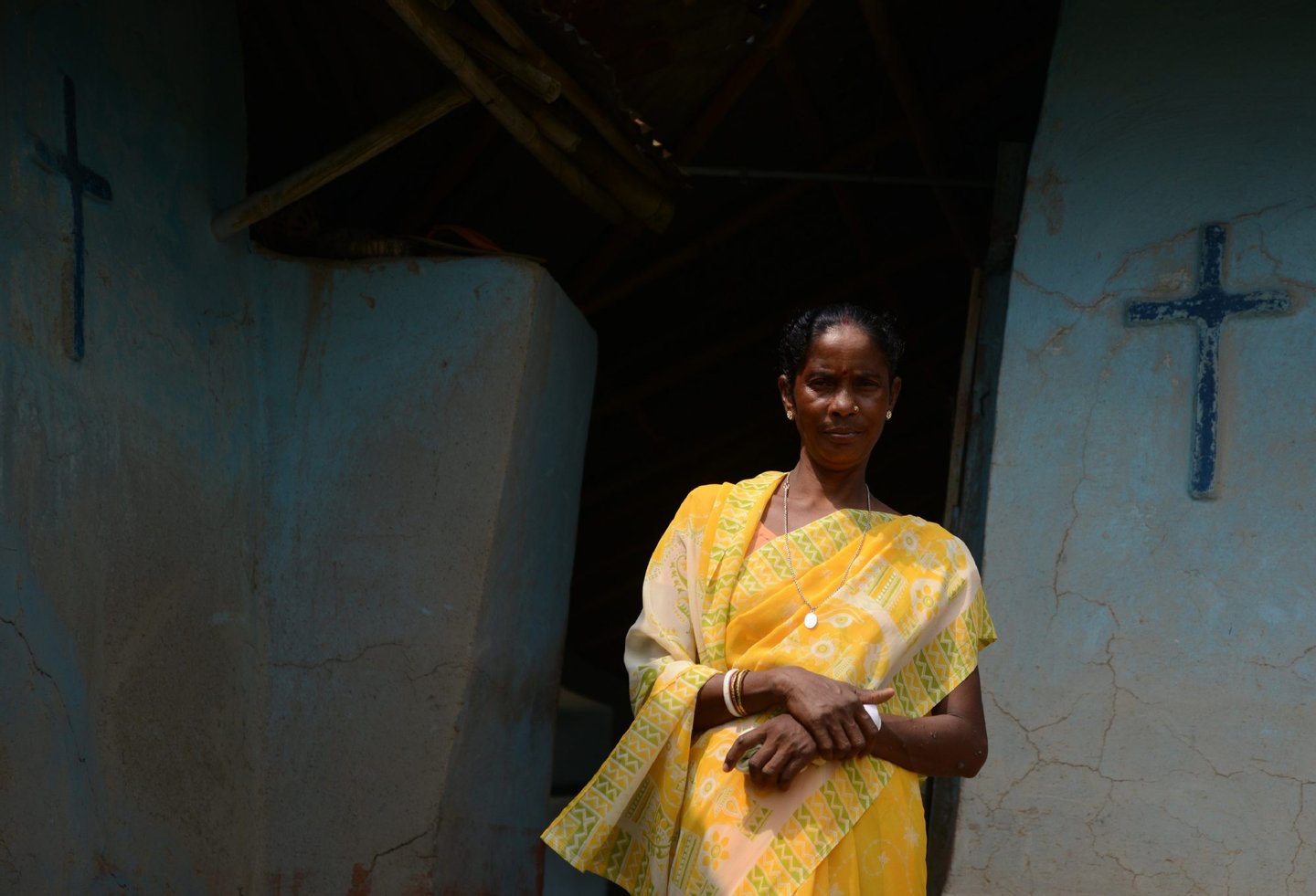 In this photograph taken on September 1, 2016, Indian woman Monica Besra poses at her home village of Nakur in Danogram, 500 kilometres (310 miles) from the eastern city of Kolkata. Besra, a Bengali tribal woman, became an overnight sensation in September 1998 when she alleged that a picture and a medallion of Mother Teresa had cured a cancerous tumour. Known as the "Angel of Mercy" for serving the poor in India, Mother Teresa will be declared a saint on September 4, amid great fanfare. But as the Vatican prepares her canonisation, allegations of fraud and medical negligence cloud her legacy. / AFP / Diptendu DUTTA / TO GO WITH AFP STORY: India-belief-religion-health, by Annie Banerji (Photo credit should read DIPTENDU DUTTA/AFP/Getty Images)