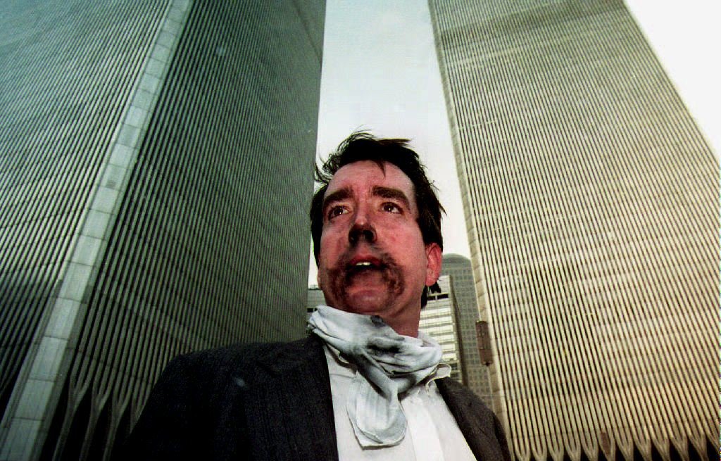 NEW YORK, UNITED STATES: Brian Rolchford stands outside the World Trade Center after walking down from the 105th floor. Smoke swept through the 110-story building after an explosion caused the ceiling of a train station to collapse 26 February 1993. The explosion set off a fire below the twin towers. (Photo credit should read TIM CLARY/AFP/Getty Images)