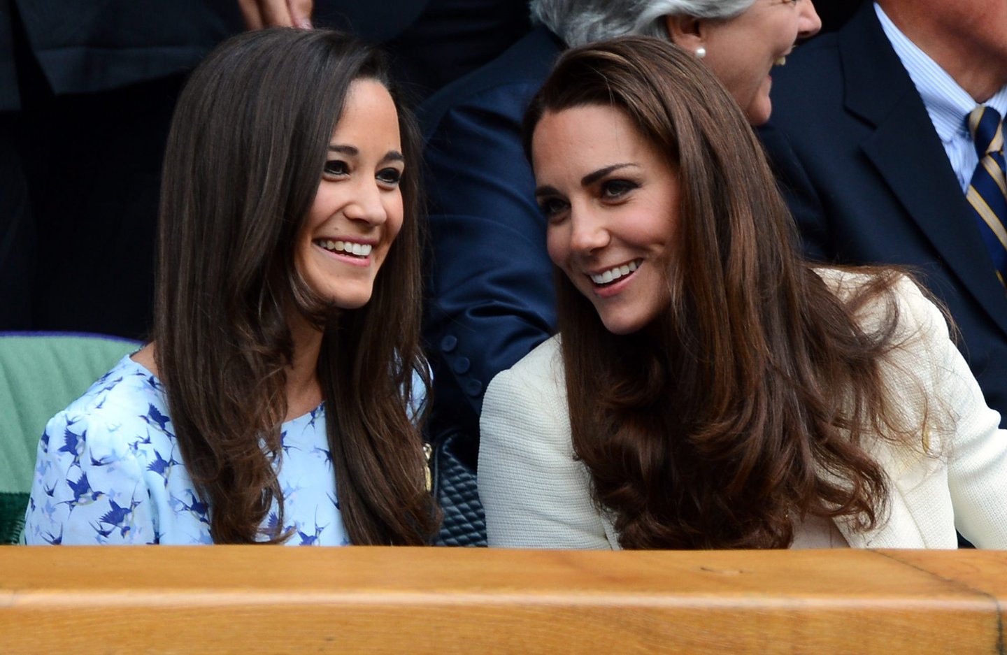 Catherine, Duchess of Cambridge (R) and her sister Pippa Middleton talk in the Royal Box before the men's singles final match between Britain's Andy Murray and Switzerland's Roger Federer on Centre Court on day 13 of the 2012 Wimbledon Championships tennis tournament at the All England Tennis Club in Wimbledon, southwest London, on July 8, 2012. AFP PHOTO / LEON NEAL RESTRICTED TO EDITORIAL USE (Photo credit should read LEON NEAL/AFP/GettyImages)